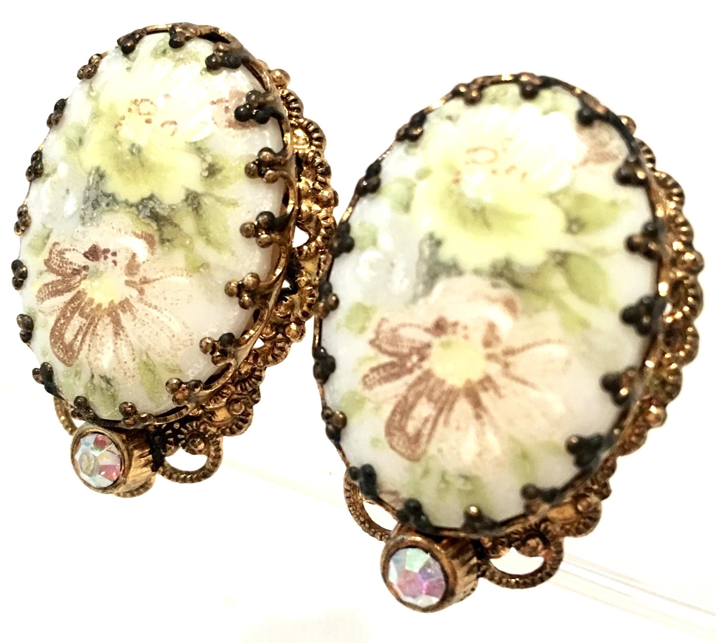 20th Century German Pair Of Gold Plate & Hand Painted Porcelain Earrings. Features gold plate fancy prong set hand painted porcelain stones with a floral motif. Each earrings has a single Austrian Aurora Borealis stone detail at the top of the