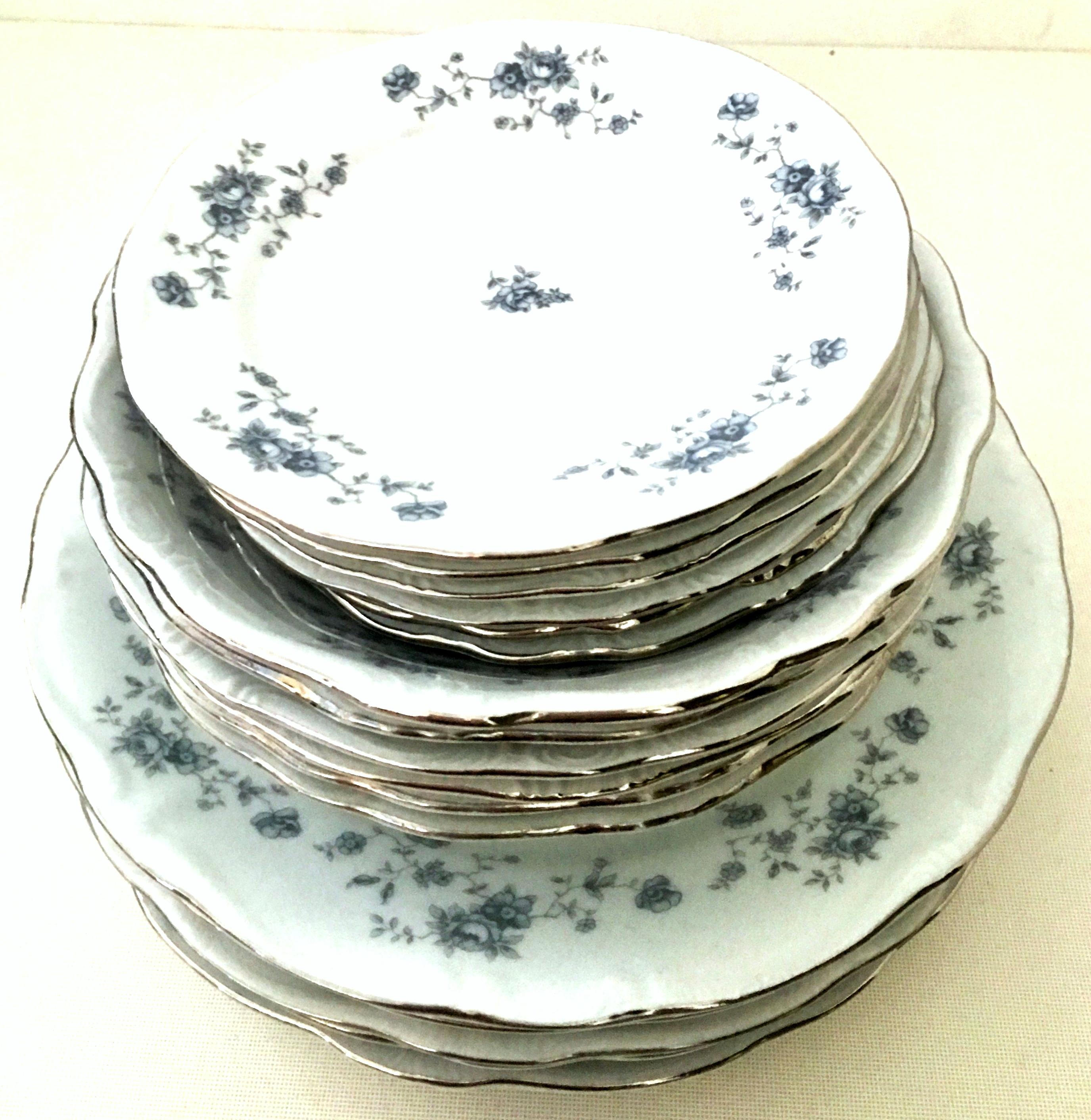 20th century German Porcelain and platinum dinnerware set of 18 by Johann Haviland. The blue Garland pattern features a bright white ground with blue floral motif, scallop and raised edge and silver platinum rim. This 18-piece set includes, six