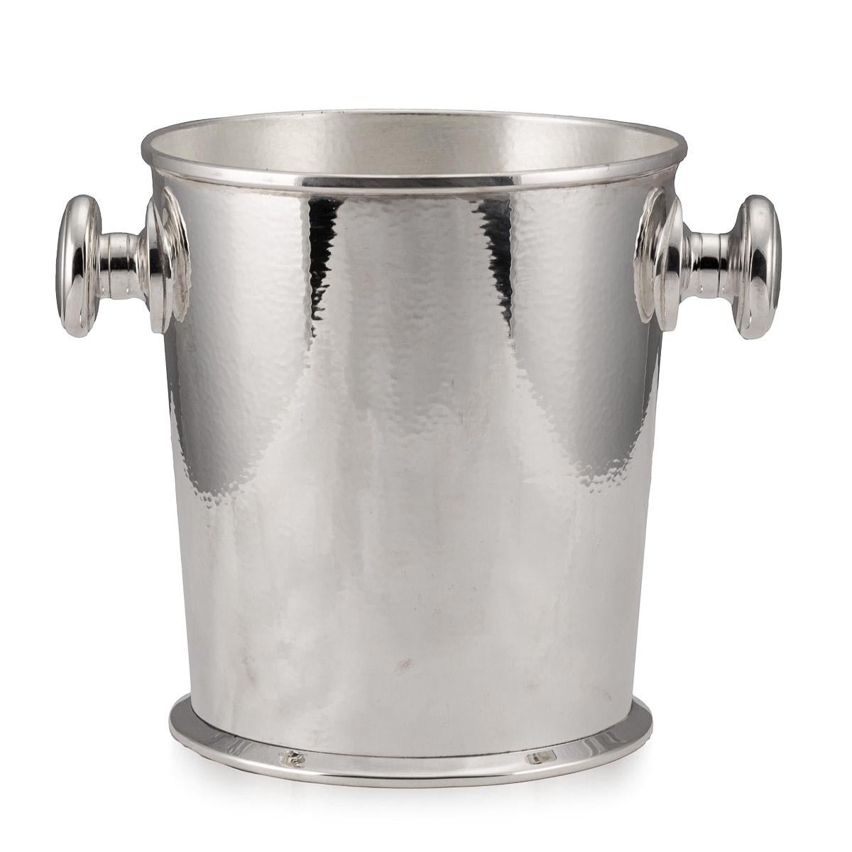 A lovely wine cooler in silver plate, made in the middle part of the 20th century in central Europe, probably Germany. The wonderful hammered effect finish, sometimes referred to as martele’ (French word for hammered), gives this special item a