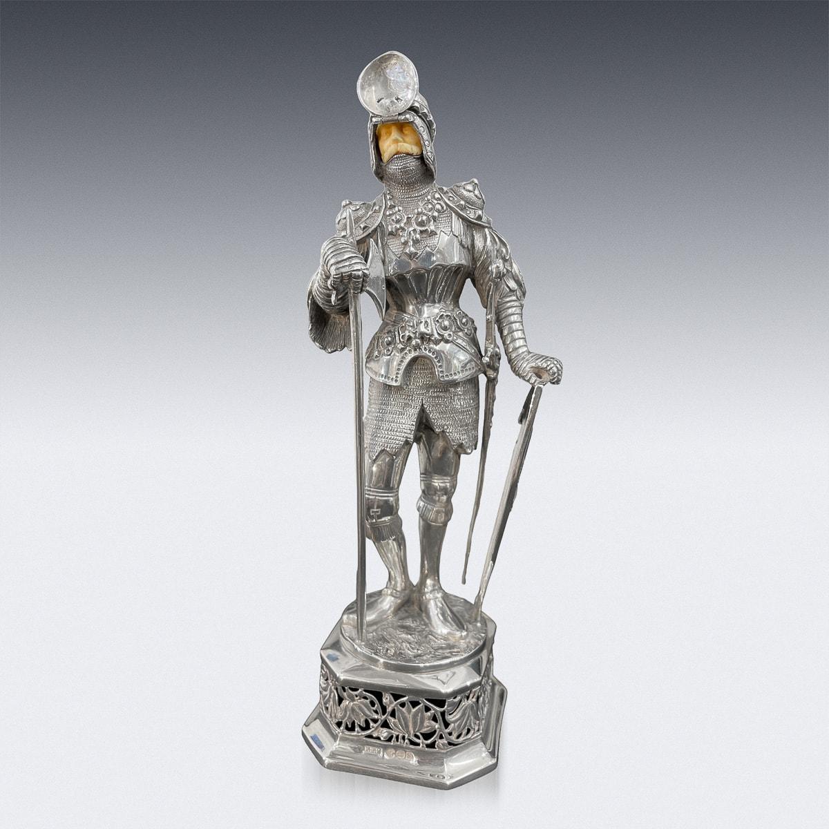Antique early-20th Century German solid silver knight figure, parcel gilt and modelled as a medival knight in full suits of armour, carved face beneath a hinged visor, sporting an axe and a shield.
This statue stands on a large embellished pedestal