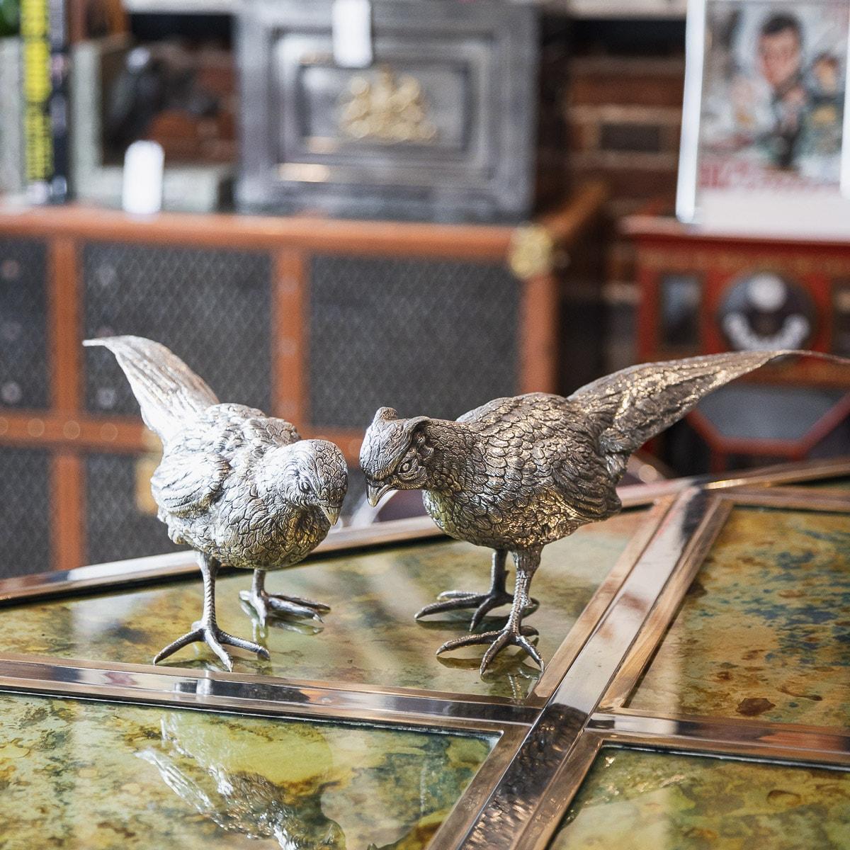 Antique early 20th century German pair of solid silver table ornaments modelled as a male and female pheasants, each statue is naturalistic and well-refined, perfect to adorn a table or fireplace during the festive season. Hallmarked German Silver