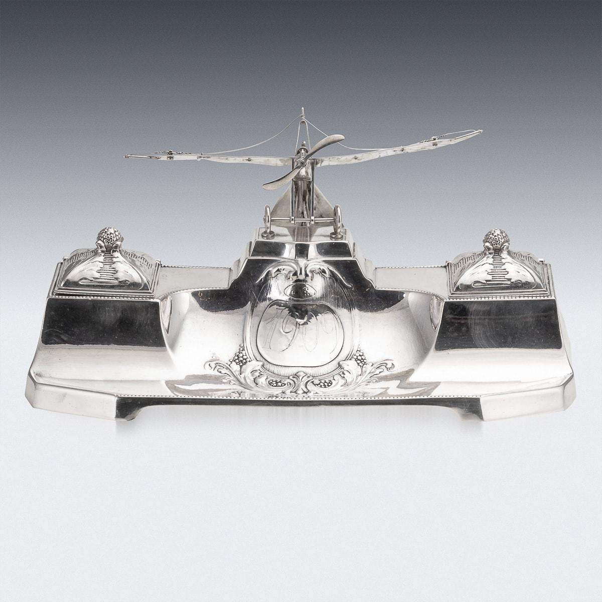 Antique early 20th Century German silver plated inkwell designed with a propeller plane detailing on top. This item was manufactured in Germany by Württemberg Metal Factory (WMF mark). The top is hinged and opens to reveal two separate glass ink pot