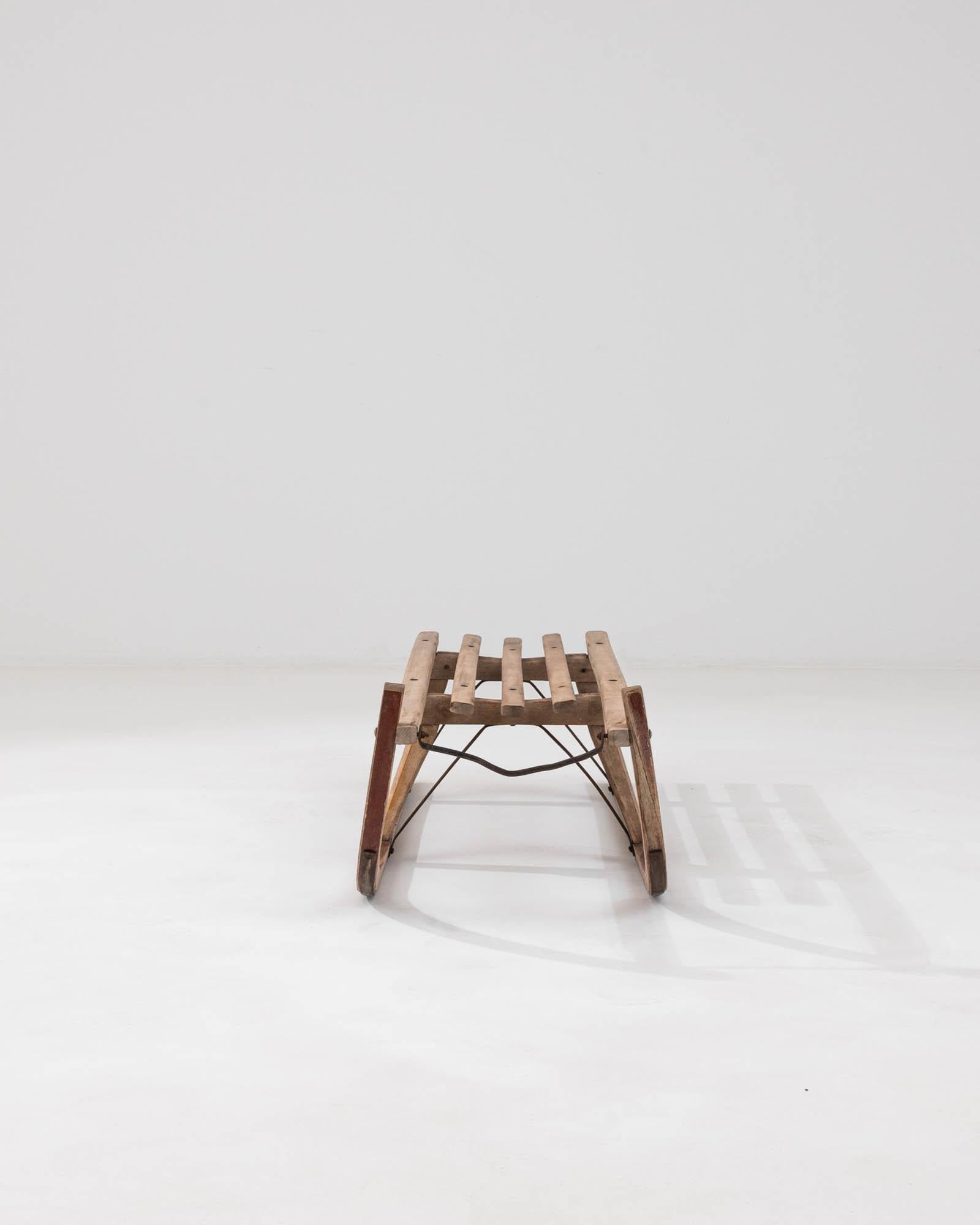 Introducing a remarkable piece of winter's past: the 20th Century German Wooden Sled by Davos. A nostalgic tribute to the snowy days of yore, this sled is a genuine collector's item, evoking the simple joy of gliding over a fresh blanket of snow.