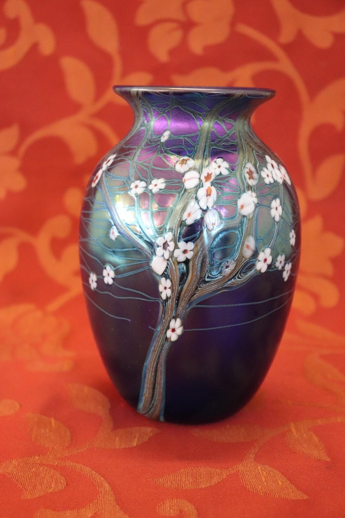 Important and refined Germany art nouveau vase. Spectacular coloration of the glass with embossed enamel decoration of floral taste. Signed and numbered at the base