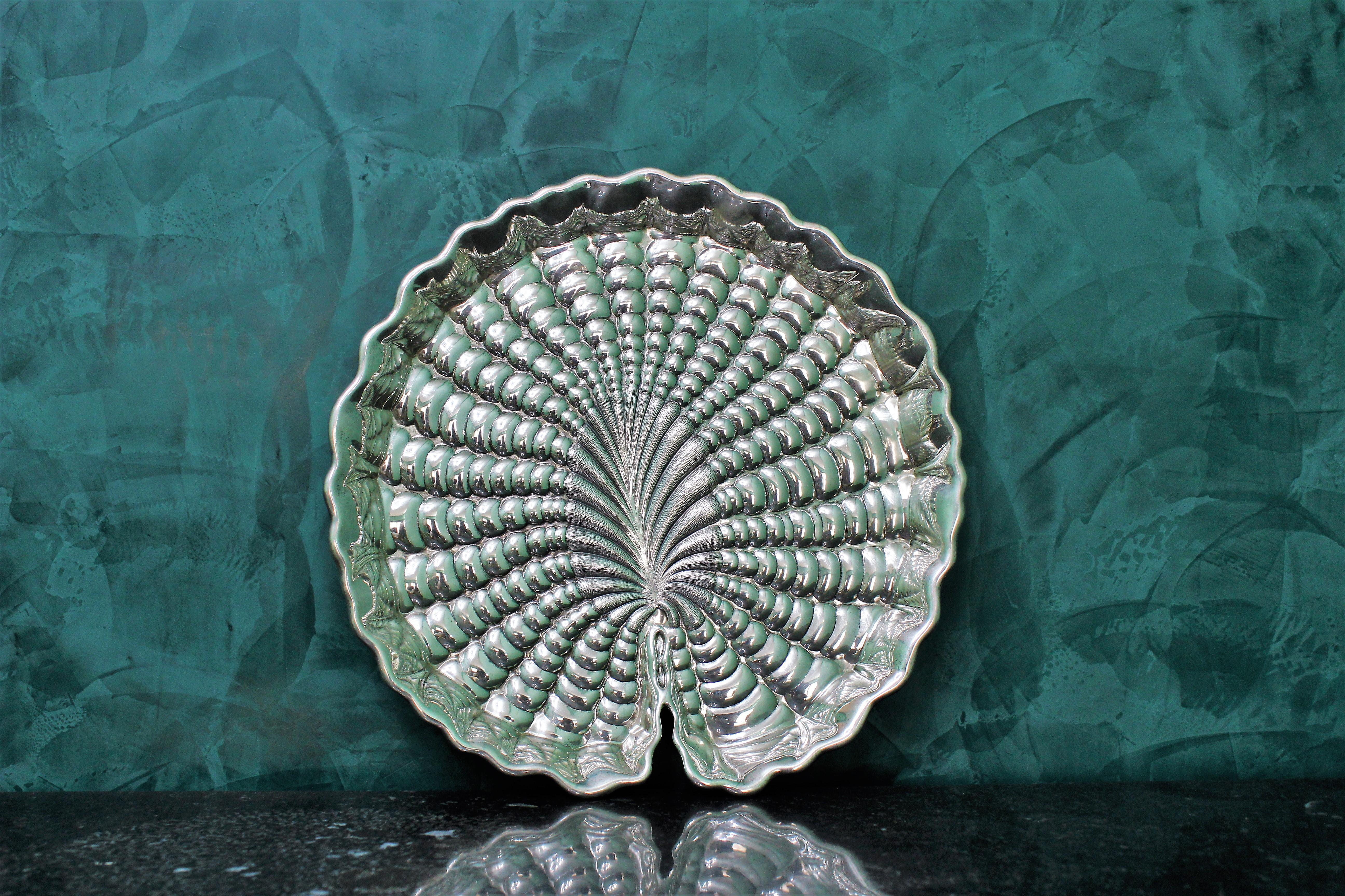 Sterling silver centerpiece nymphaea/water lily leaf embossed and engraved by hand with a magnificent work.
Can be used as an elegant and precious centerpiece the way it is or used as a serving plate.
Signed by Gianmaria Buccellati - Milan and