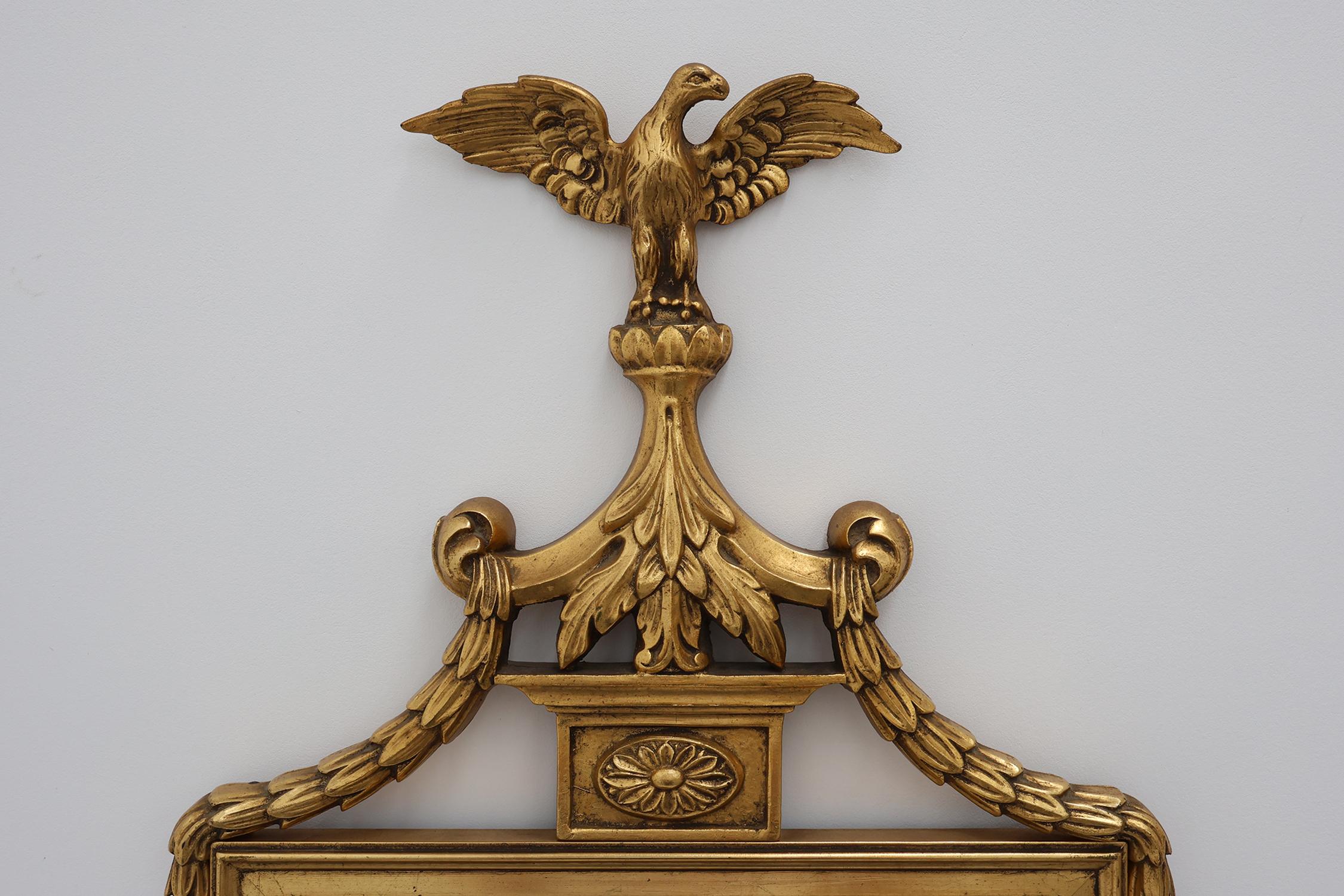 Belga 20th Century gilded wooden Empire style mirror with eagle on top in vendita