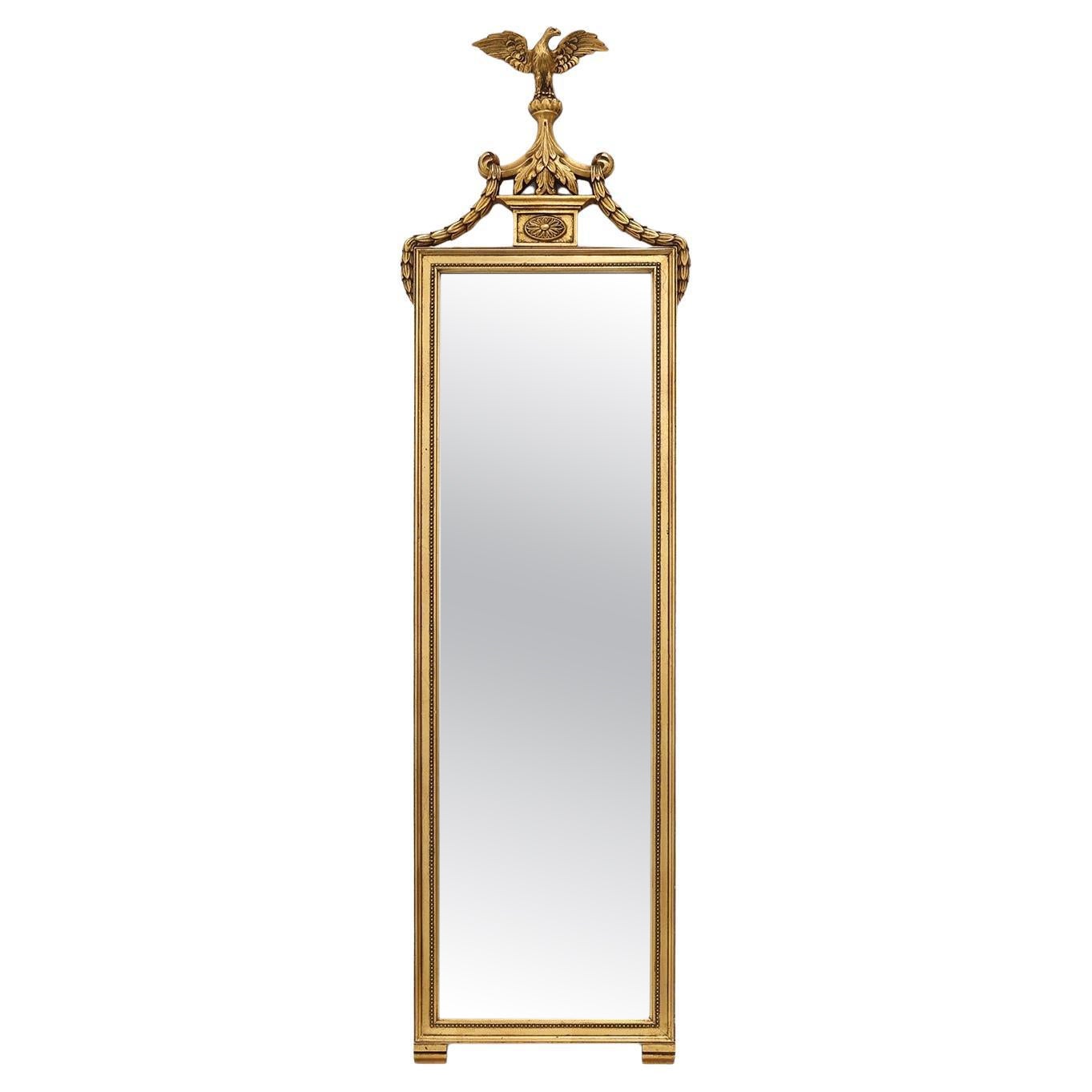 20th Century gilded wooden Empire style mirror with eagle on top