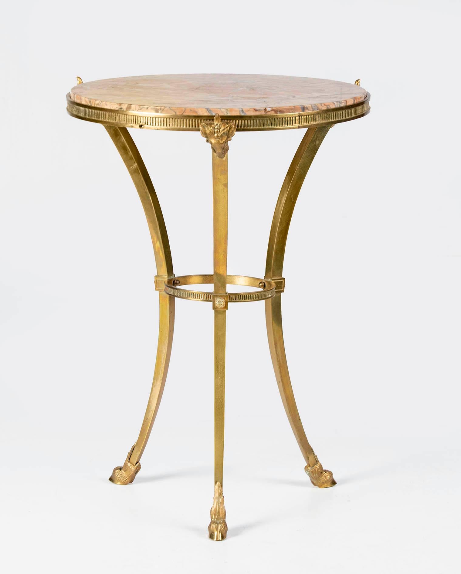An elegant side table in Maison Jansen style in French Napoleon III style. The base is a solid bronze tripod. Embellished with mercury gilded bronze ram's heads and legs. On the top a pink marble. The pink marble combines beautifully with the