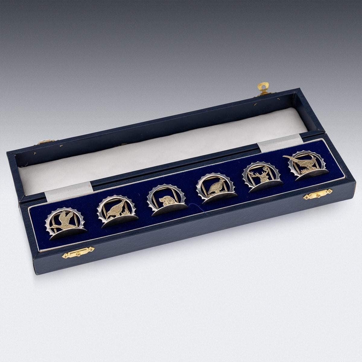 A superb late 20th Century solid silver set of six menu holders, each holder modelled as different gilt animals. Presented in the original box. Each menu holder is Hallmarked English silver (925 Standard), London, year 1987 (N), Maker's mark A