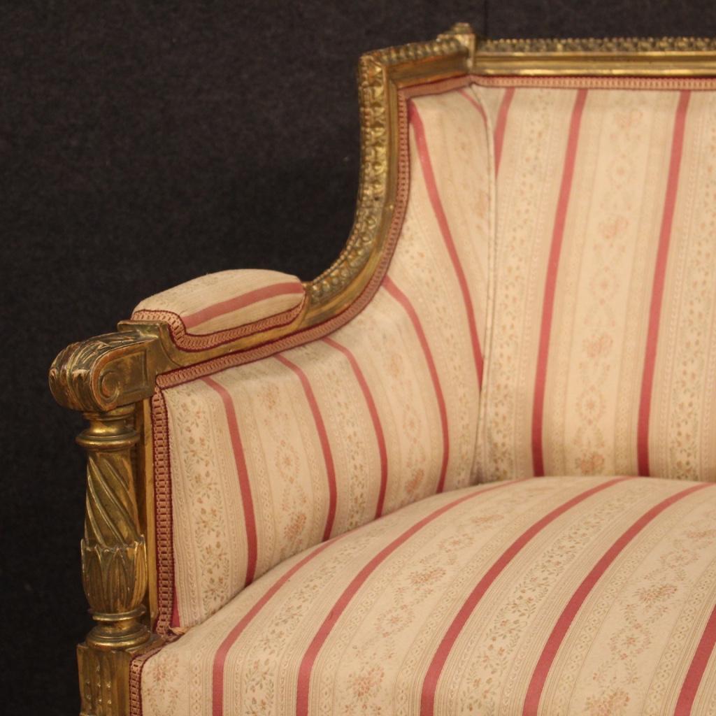 Italian sofa from the mid-20th century. Louis XVI style furniture in carved and gilded wood of beautiful line and pleasant decor. Two-seat sofa, finished for the center, supported by four carved legs. Padding in fair condition, to be revised for