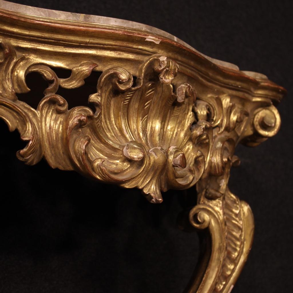 20th century French console in Louis XV style. Furniture in richly carved and gilded wood of excellent quality. Wall-console with original marble top. Marble that has undergone a minor restoration in a corner, now in good condition. Furniture of