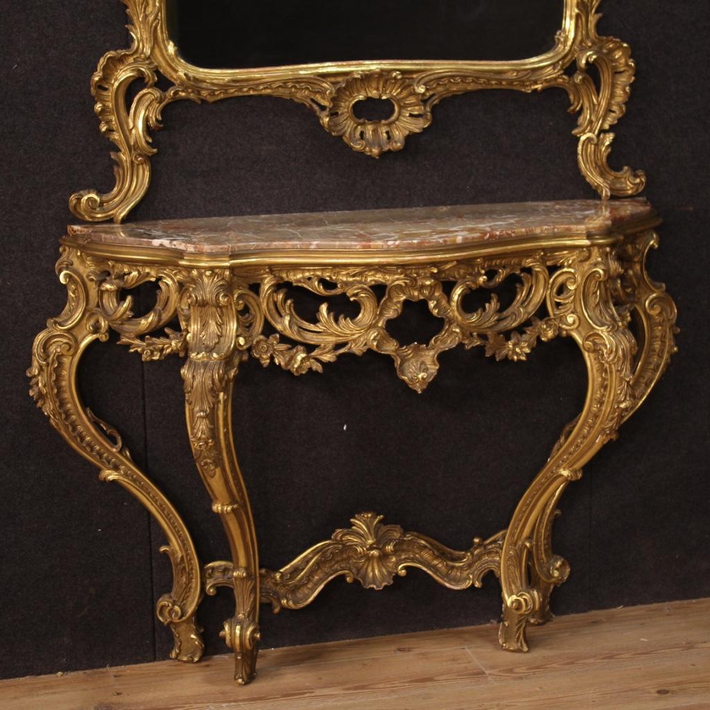 French console with mirror from the mid-20th century. Furniture in carved and gilded wood in Louis XV style of great quality and impact. Console supported by four legs to be fixed to the wall for perfect stability. Furniture fitted with a built-in