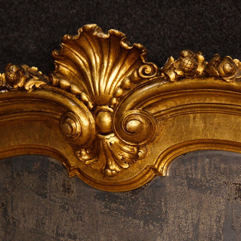 Italian mirror from 20th century. Furniture in richly carved and gilded wood and plaster, of beautiful decoration. Mirror ideal to combine with a dresser or bureau. Mirror composed of 9 antiqued mirrors in perfect condition, without chipping or