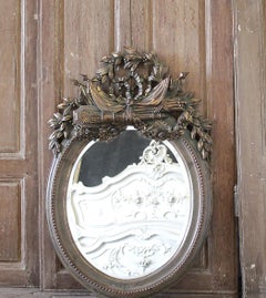 Miroir en bois doré sculpté avec biseau, XXe siècle