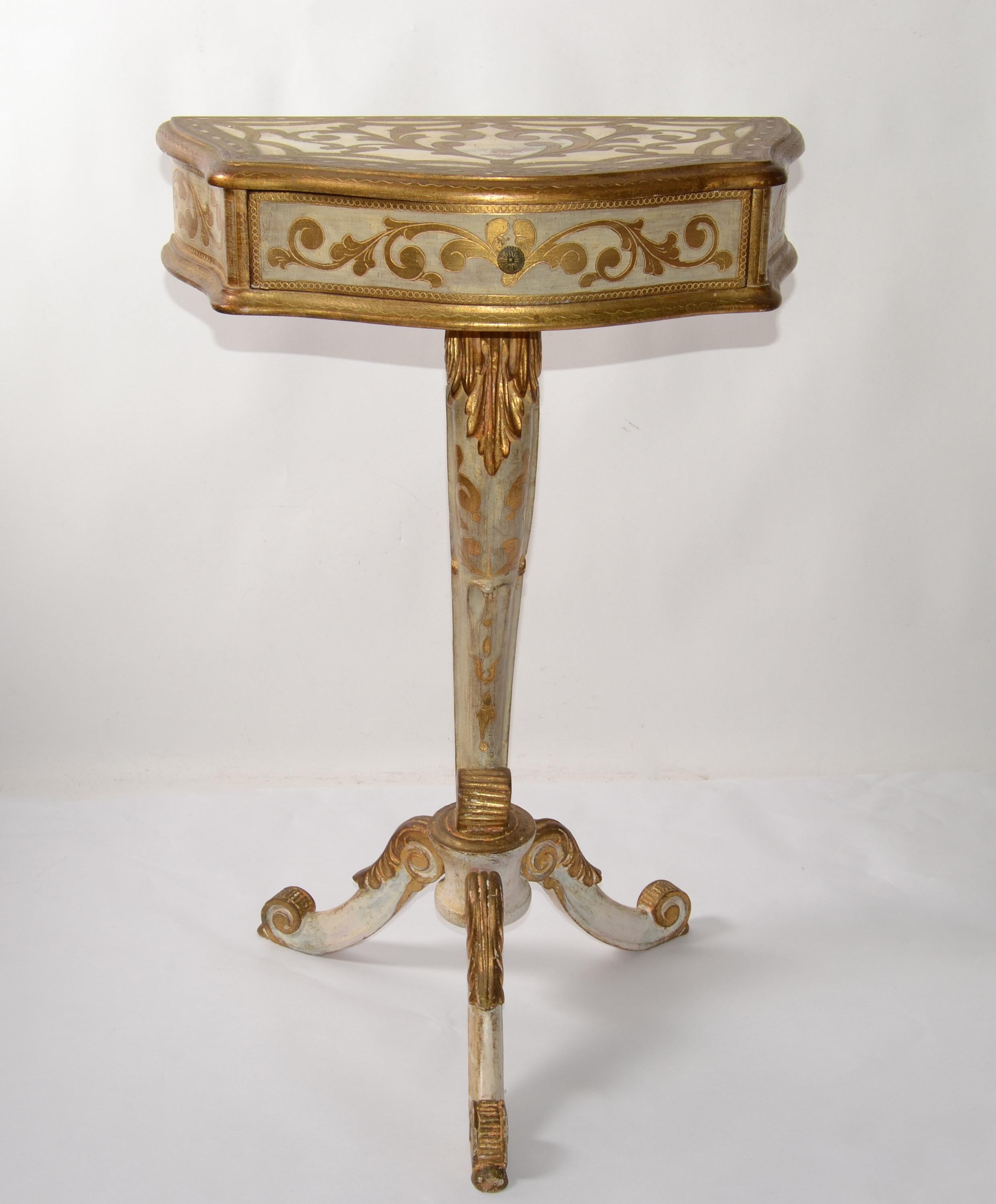 This most elegant and charming Italian 20th century Florentine giltwood side table. The rectangle top side table is raised by three elegantly curved legs with fine scrolled feet and stunning palmette designs. 
The tusk shaped central support