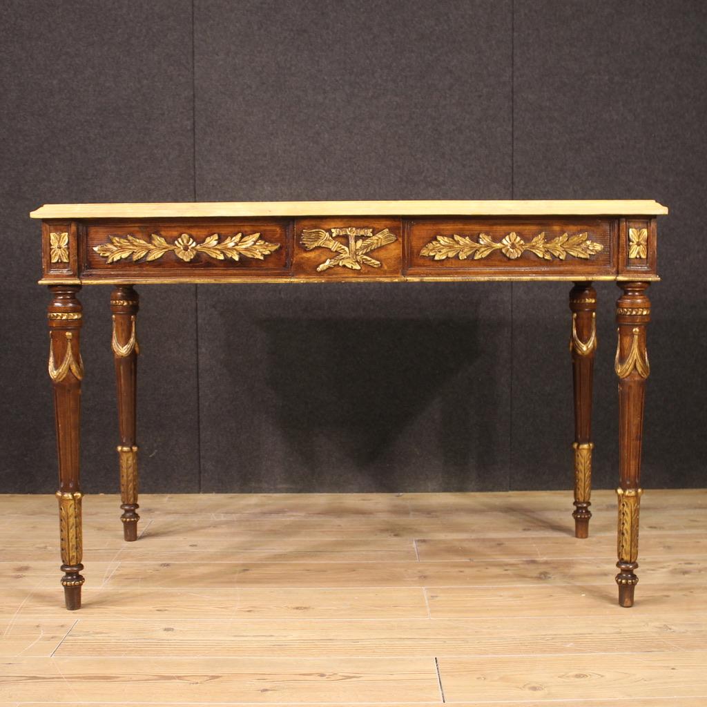 Italian console table from the second half of the 20th century. Sculpted, lacquered and gilded furniture in beech and fruitwood in the Louis XVI style. Finished furniture for the center equipped with a faux marble lacquered wooden top of good Size