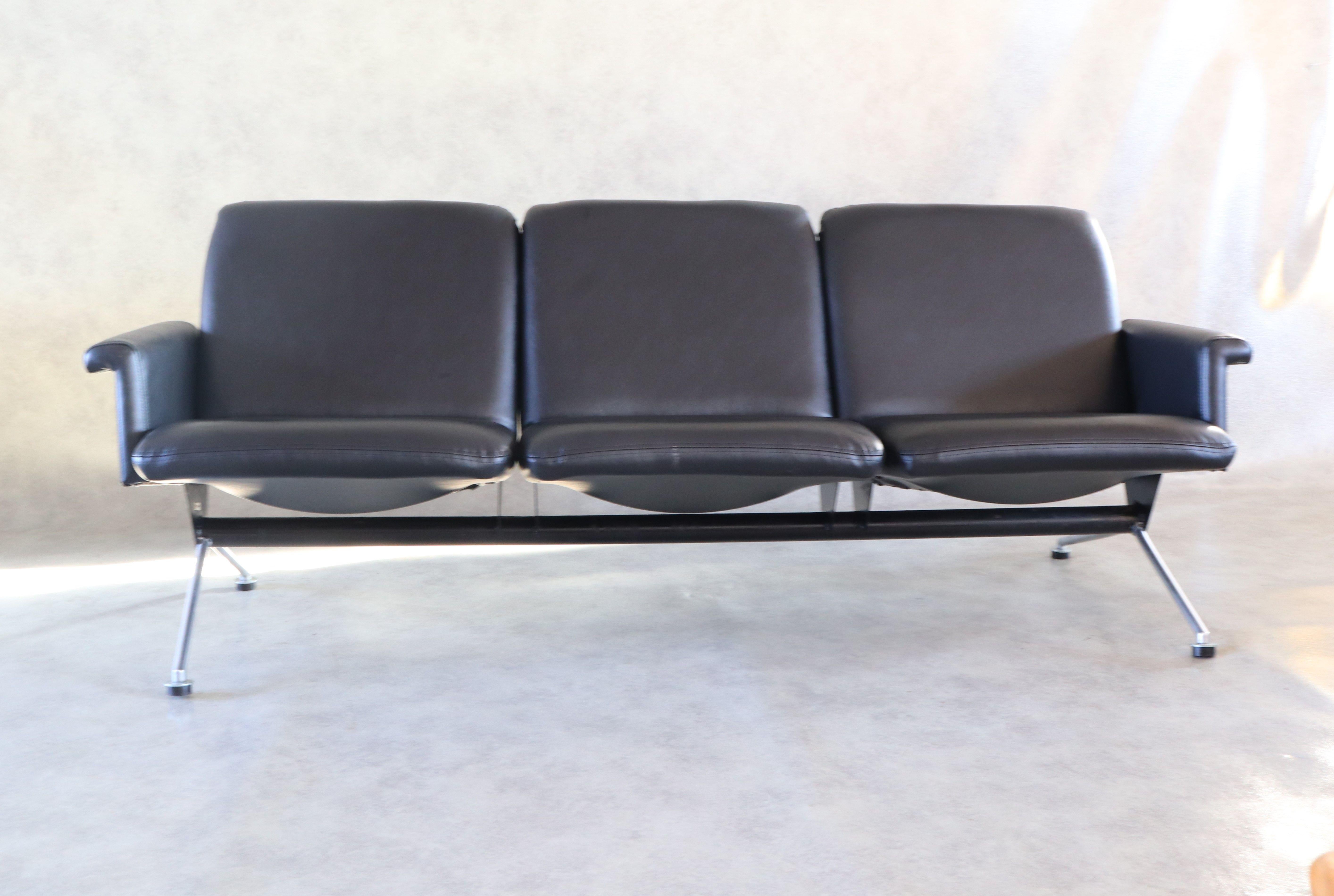 Rare Mid-Century Modern sofa with armrests no. 1715 by Andre Cordemeijer for Gispen, 1961.
Graphite-black lacquered metal frame with chrome-plated legs. Re-upholstered in black faux leather. 
In their brochure, Gispen advertised the sofa's