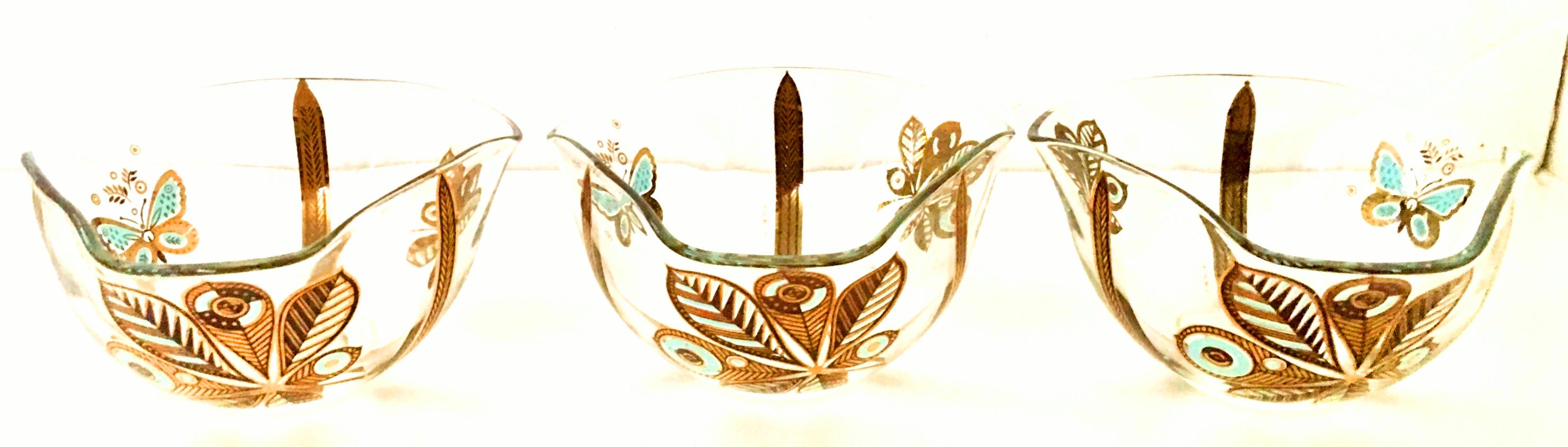 20th century Hollywood Regency set of three 22-karat gold and turquoise printed organic form butterfly and fauna motif glass bowls by, Georges Briard. Each piece is signed on the exterior side with the Geroges Briard trademark.