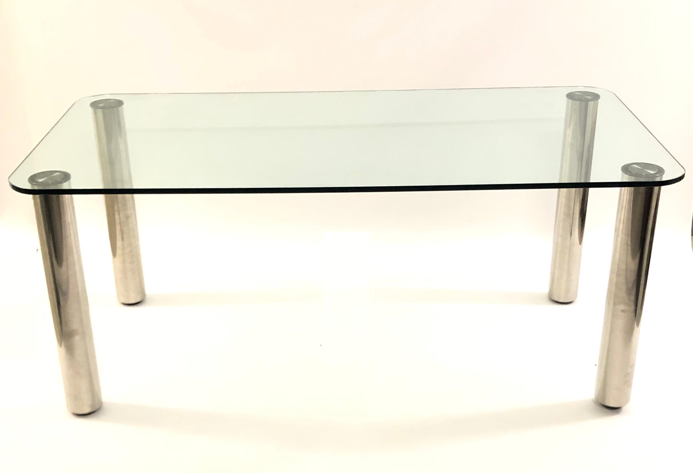 Italian 1970s glass dining table having a slightly tinted, thick glass top with rounded corners, on chrome legs

The legs are detachable for ease of transport.

Bearing 'Made in Italy' mark to steel mount on glass top.
