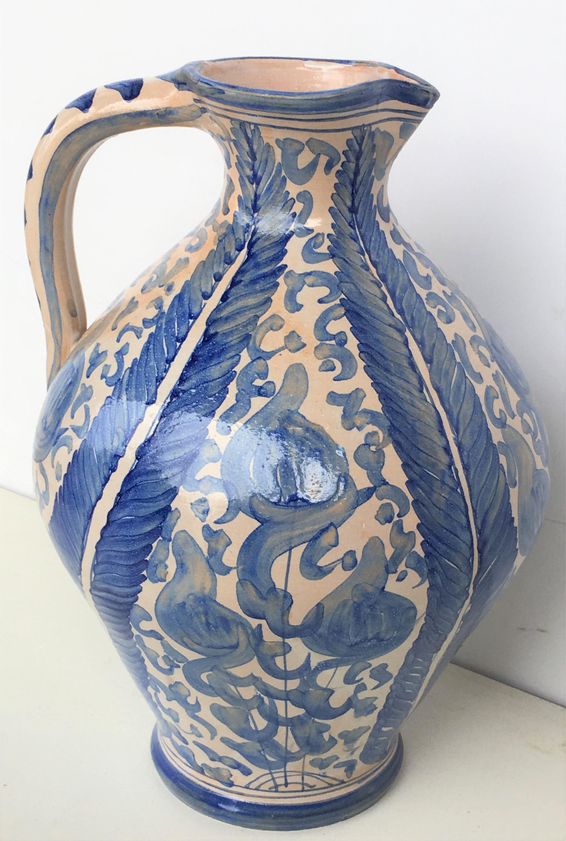 A striking Spanish glazed earthenware handled blue and white painted vessel, the body underglaze blue ornamental decorated .
Vessel of porous clay, with a bulging belly, a circular handle on the upper part, a mouth to fill it and an outlet to