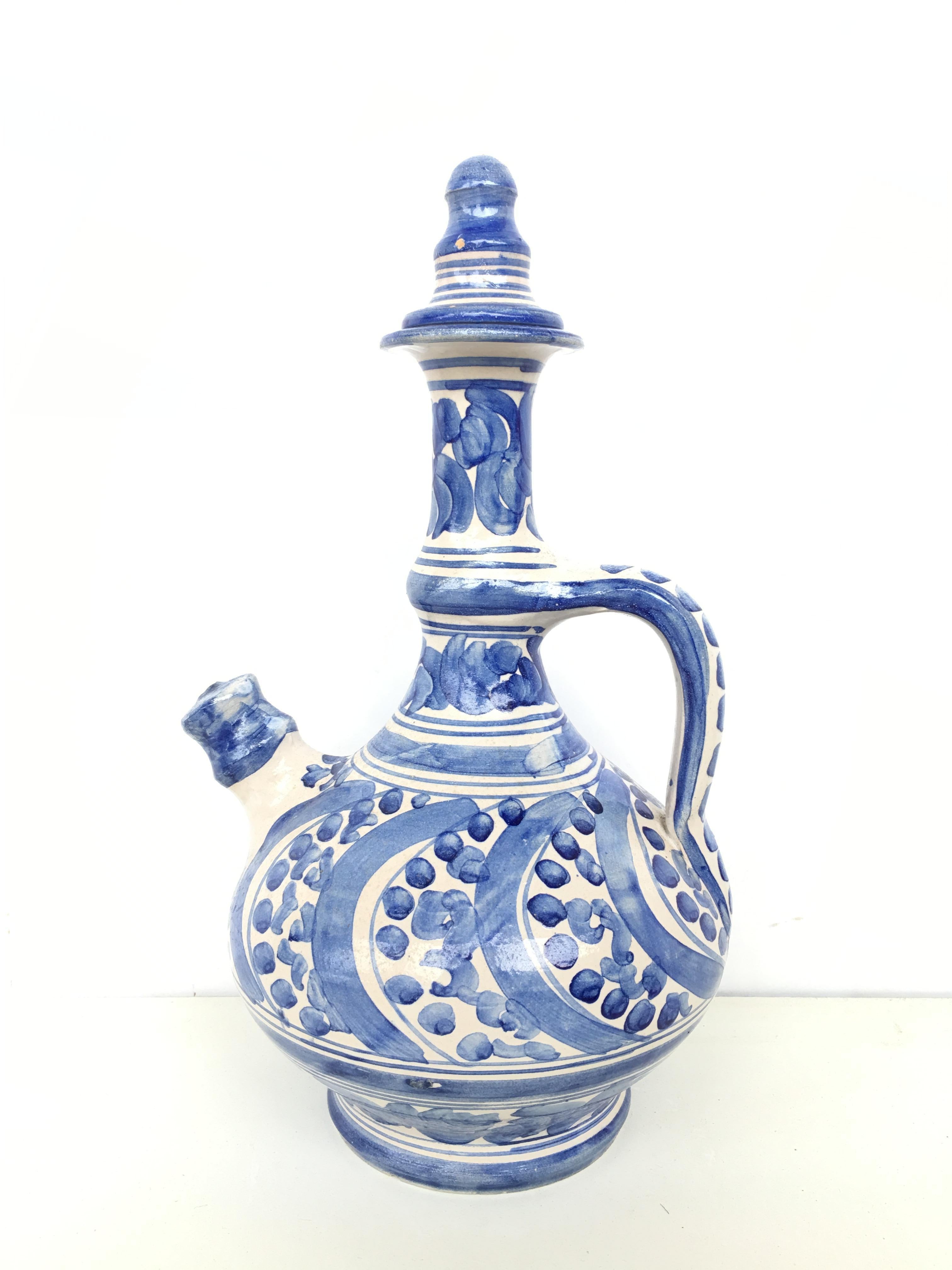 A striking Spanish glazed earthenware handled blue and white painted pitcher , the body underglaze blue ornamental decorated .

It´s a 