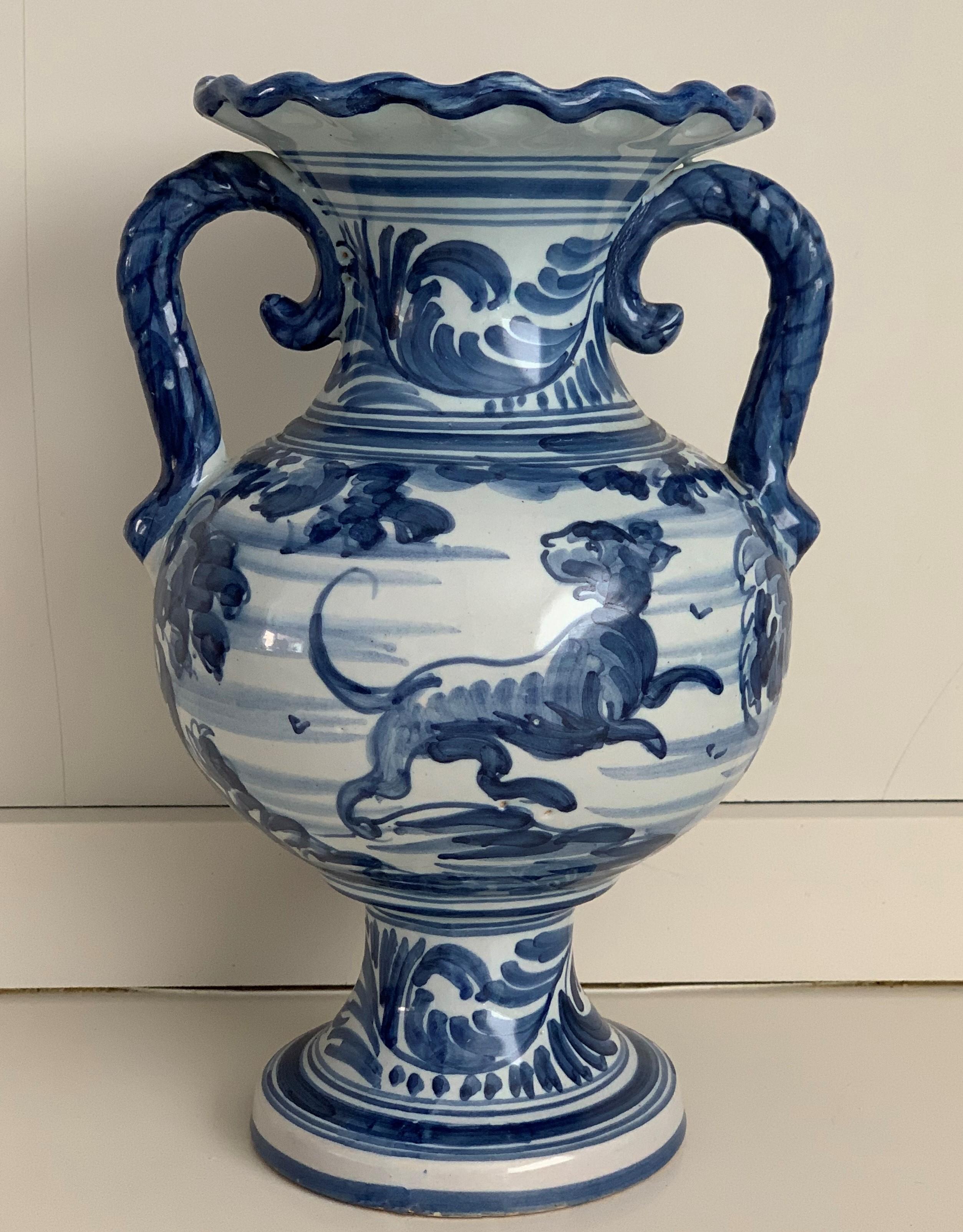 A striking Spanish glazed earthenware two-handled blue and white painted urn with handles, the body underglaze blue and white decorated very tipycal of this region.

Talavera de la Reina pottery is a craft made in Talavera de la Reina, Toledo