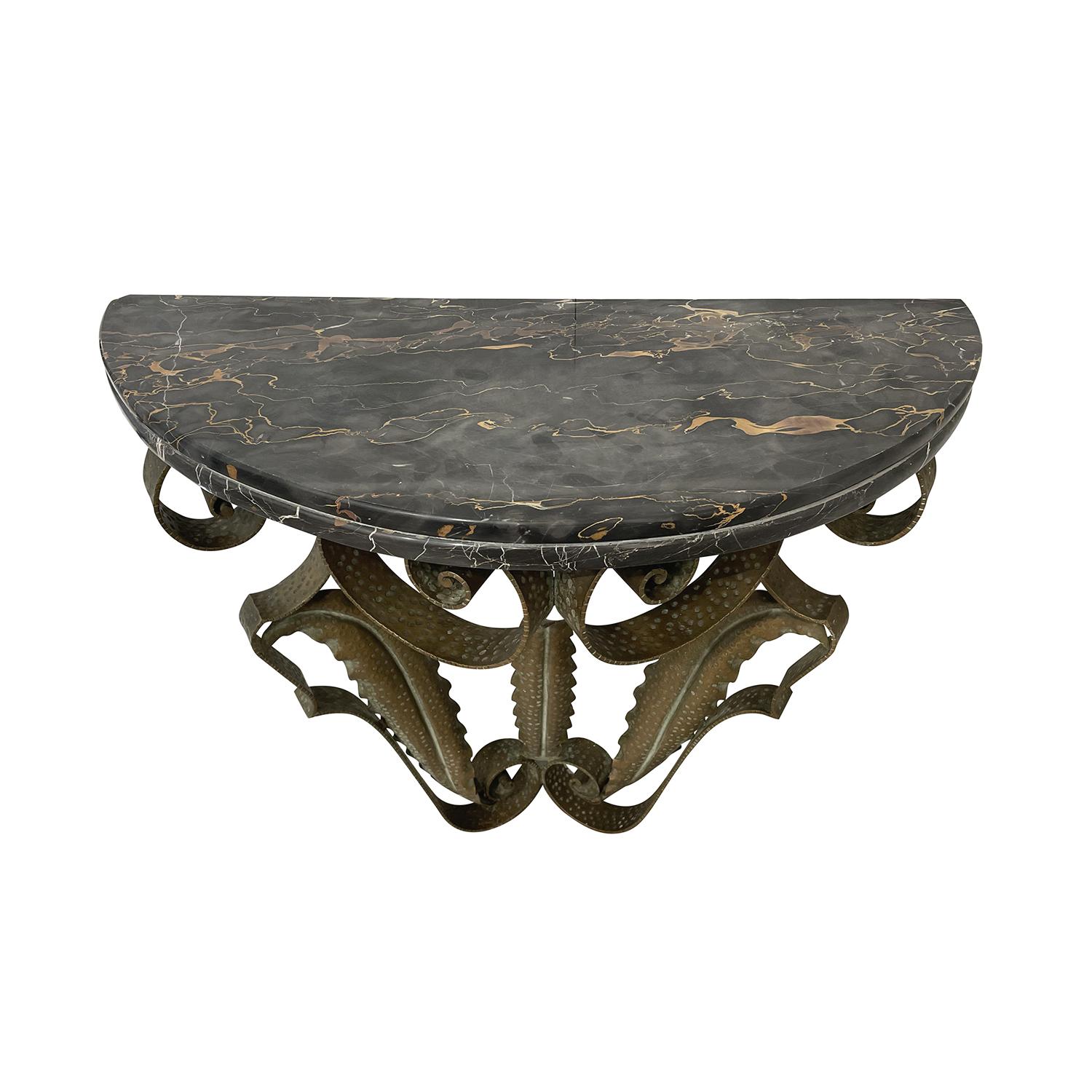 A half round, vintage Mid-Century Modern Italian wall mounted console table made of handcrafted gilded metal with a black marble top, designed by Pier Luigi Colli, in good condition. The small demilune side table is enhanced by detailed decoration