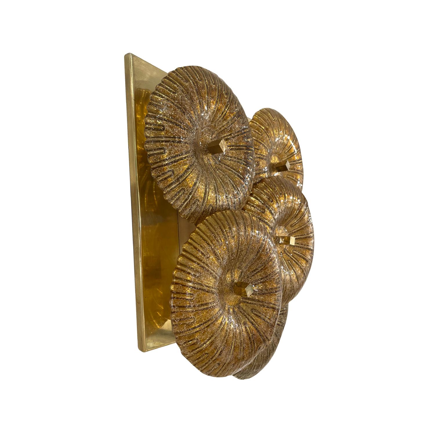 A gold-brown, vintage Mid-Century modern Italian pair of wall appliques made of hand blown smoked Murano glass, in good condition. Each wall sconce is composed with five large colored discs which are overlapping, featuring a two light socket,