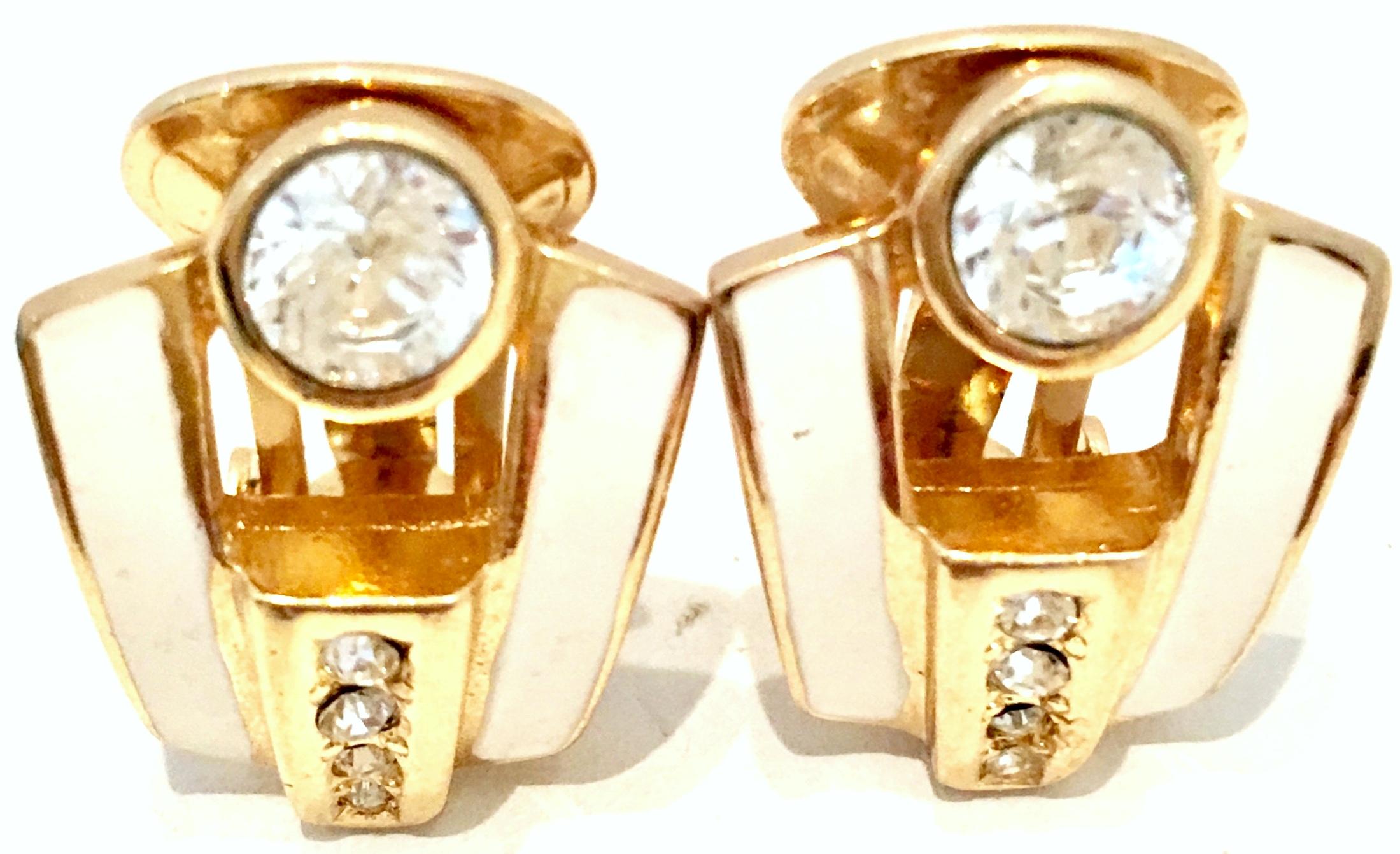20th Century Pair Of Gold Plate, Enamel & Swarovksi Crystal Earrings By, Christian Dior. These clip style earrings feature gold plate with ivory enamel and brilliant cut and faceted colorless Swarovski crystal pave set stones. Each piece is signed