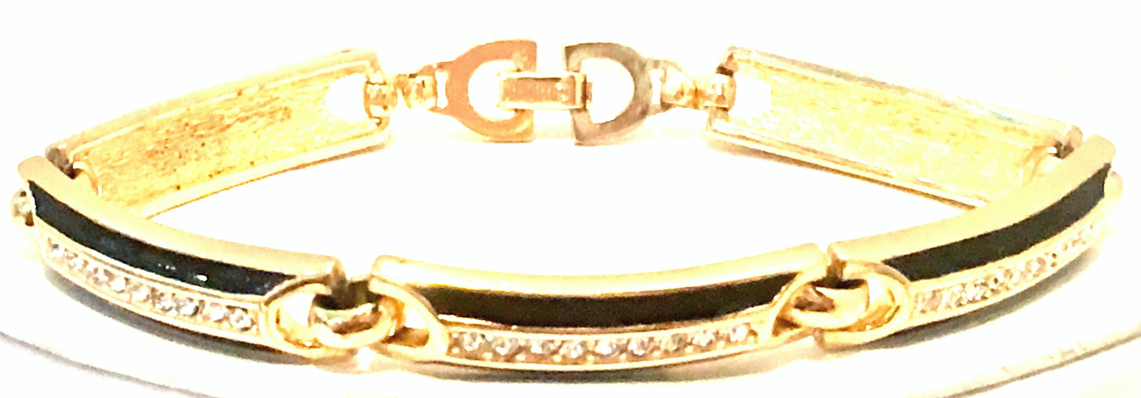 20th Century Gold Plate, Enamel & Swarovski Crystal Link Bracelet By, Christian Dior. This gold plate, black enamel and Swarovski crystal five curved link bracelet features brilliant colorless pave set crystal stones with the iconic 