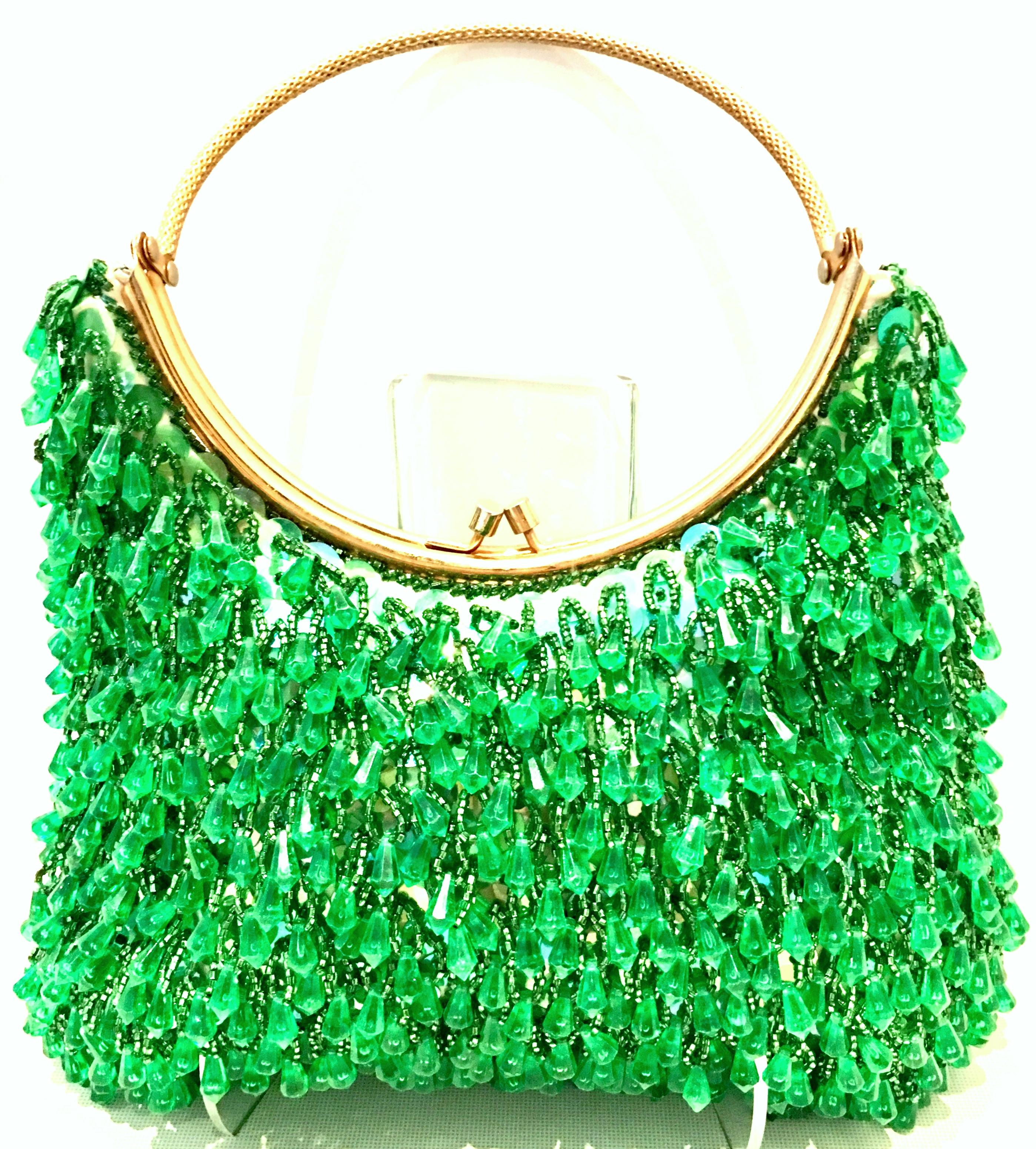 Mid-20th Century Gold Plate, Crystal Bead & Sequin Evening Bag By, Richere-Hong Kong. This rate and coveted hand bag features a gold gilt brass round handle with
vibrant green crystal beads and iridescent green sequins. Fully lined in satin with one