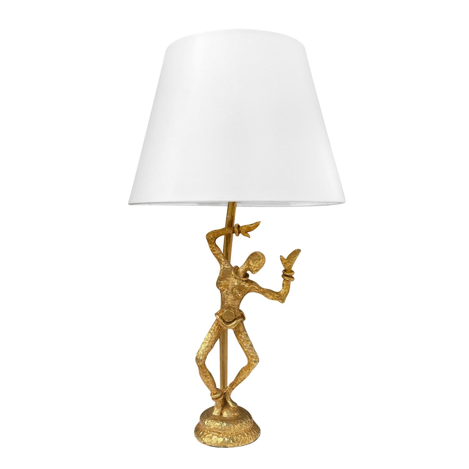 A gold, vintage Mid-Century Modern Italian single sculptural table lamp with a new round white shade, made of handcrafted gilded bronze in good condition. The detailed desk light is particularized by a female dancer, which is halted by a curved arm,