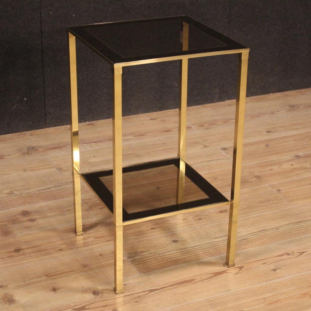 Italian side table from the 1970s-1980s. Golden metal design furniture with two shelves. Side table complete with glass shelves (without chipping, small scratches) with mirror finish on the edges (see photo) of beautiful decoration and good service.