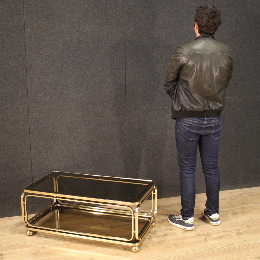 Coffee table of Italian design from the 80s / 90s. Furniture in gilded metal equipped with two shelves of good utility and service. Top signed (see photo) under study. Glass tops complete with mirrored side band (see photo), beautifully decorated