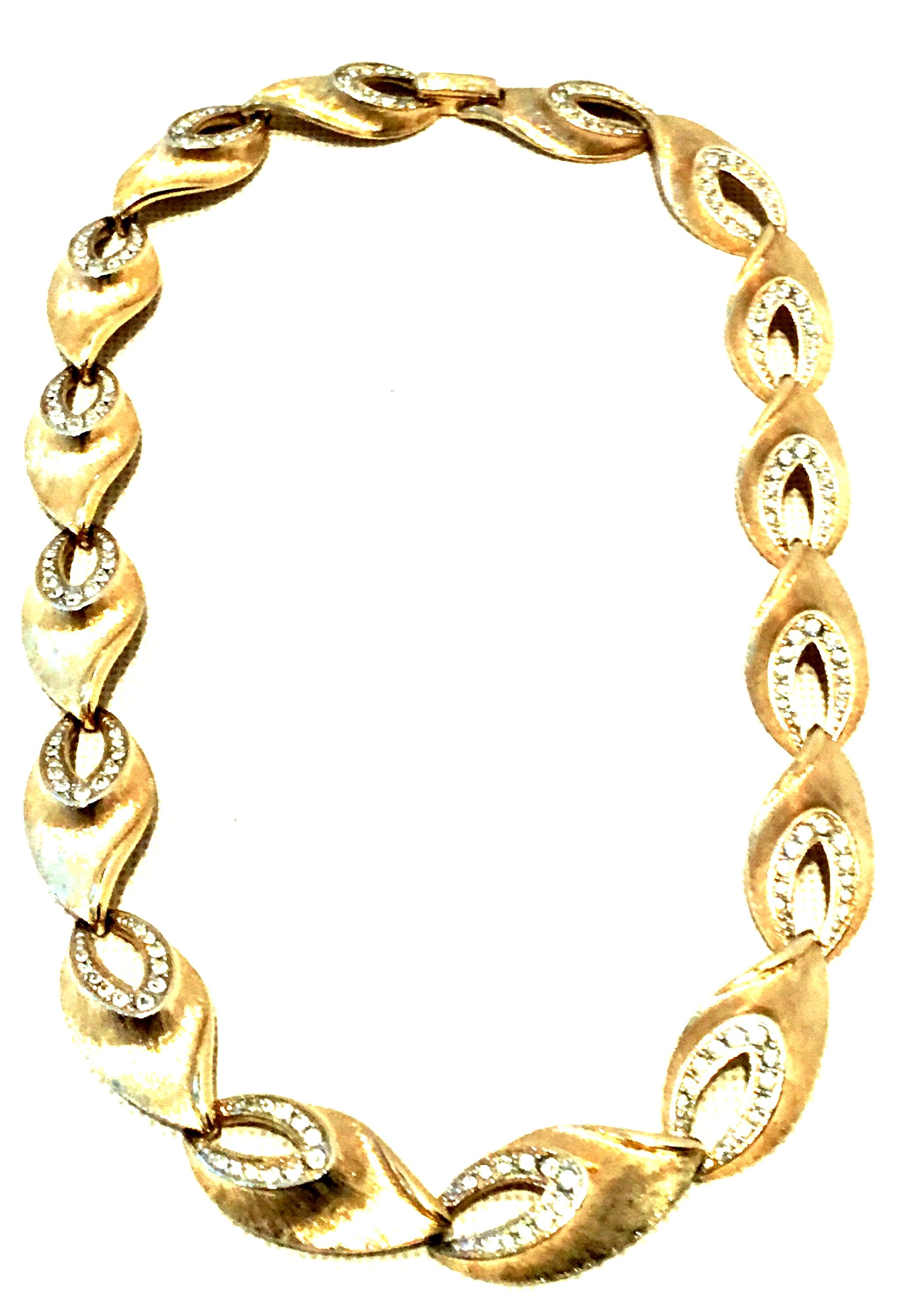 20th Century Gold Plate & Austrian Crystal Link Choker Style Necklace By, Kramer. This finely crafted brushed gold plate link choker style necklace features curved, dimensional links with brilliant cut and faceted colorless pave set Austrian crystal