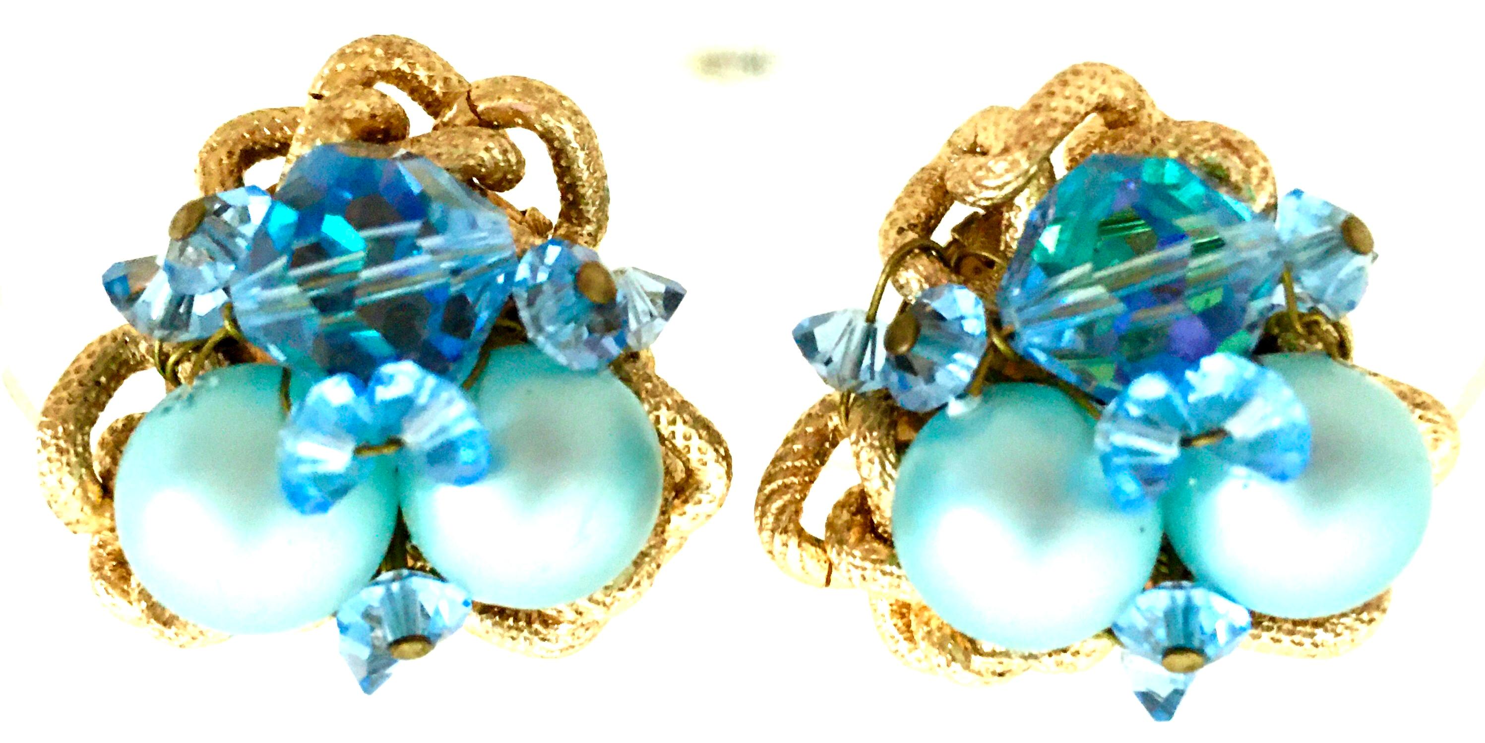 20th Century Gold Plate & Blue Bead Clip Style Pair Of Earrings. These coveted and rare pair of earrings feature a dimension design with cut and faceted sapphire blue crystal beads, robins egg blue faux pearl beads and a gold stamped rope stye