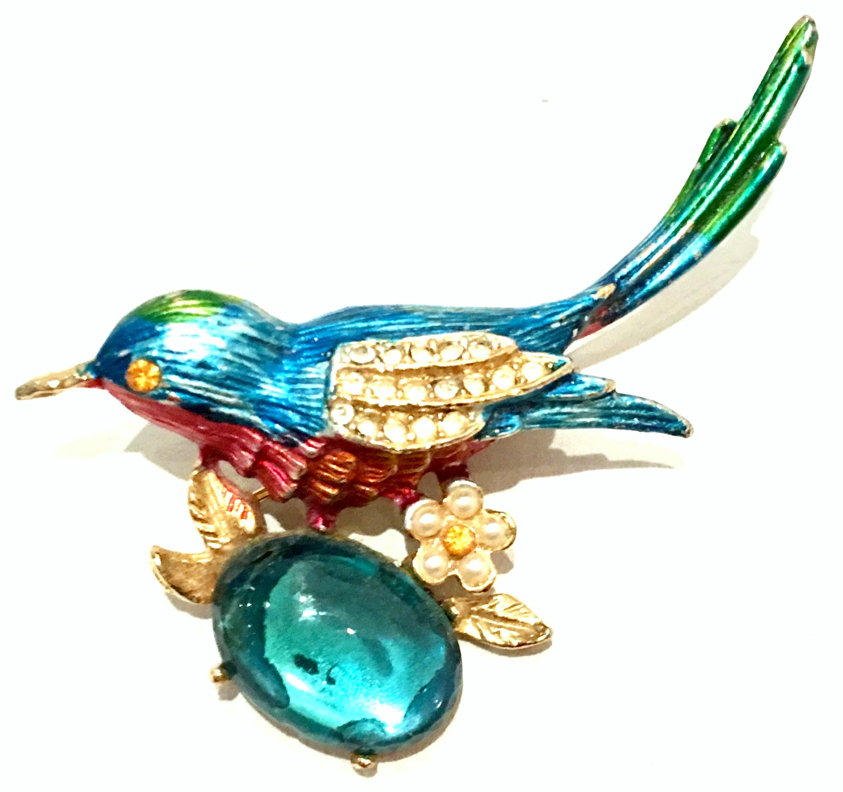 20th Century Gold Plate , Enamel & Austrian Crystal Hummingbird Brooch. Features a gold plate metal base with hand painted vivid shaded of enamel, large central fancy prong set Austrian crystal blue topaz stone with translucent pave set detail.. The