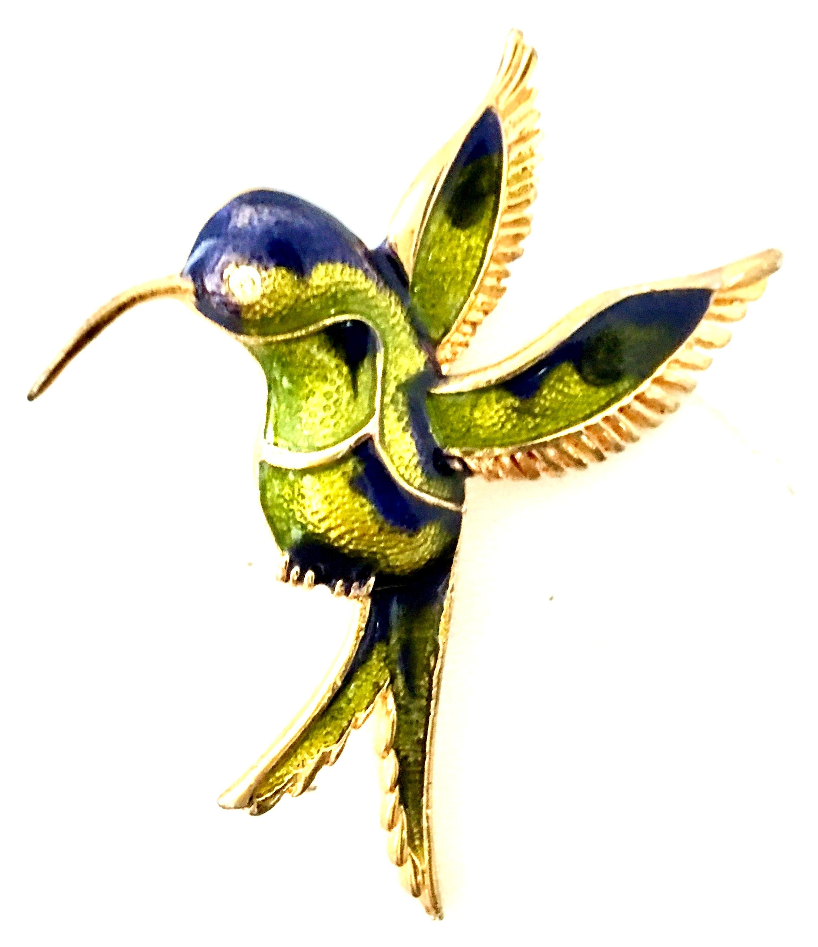 20th Century Gold Plate, Enamel & Austrian Crystal Hummingbird Brooch. Features a gold plate base metal with chartreuse green and navy blue enamel detail. The bird's eye is a single Austrian crystal clear rhinestone. 