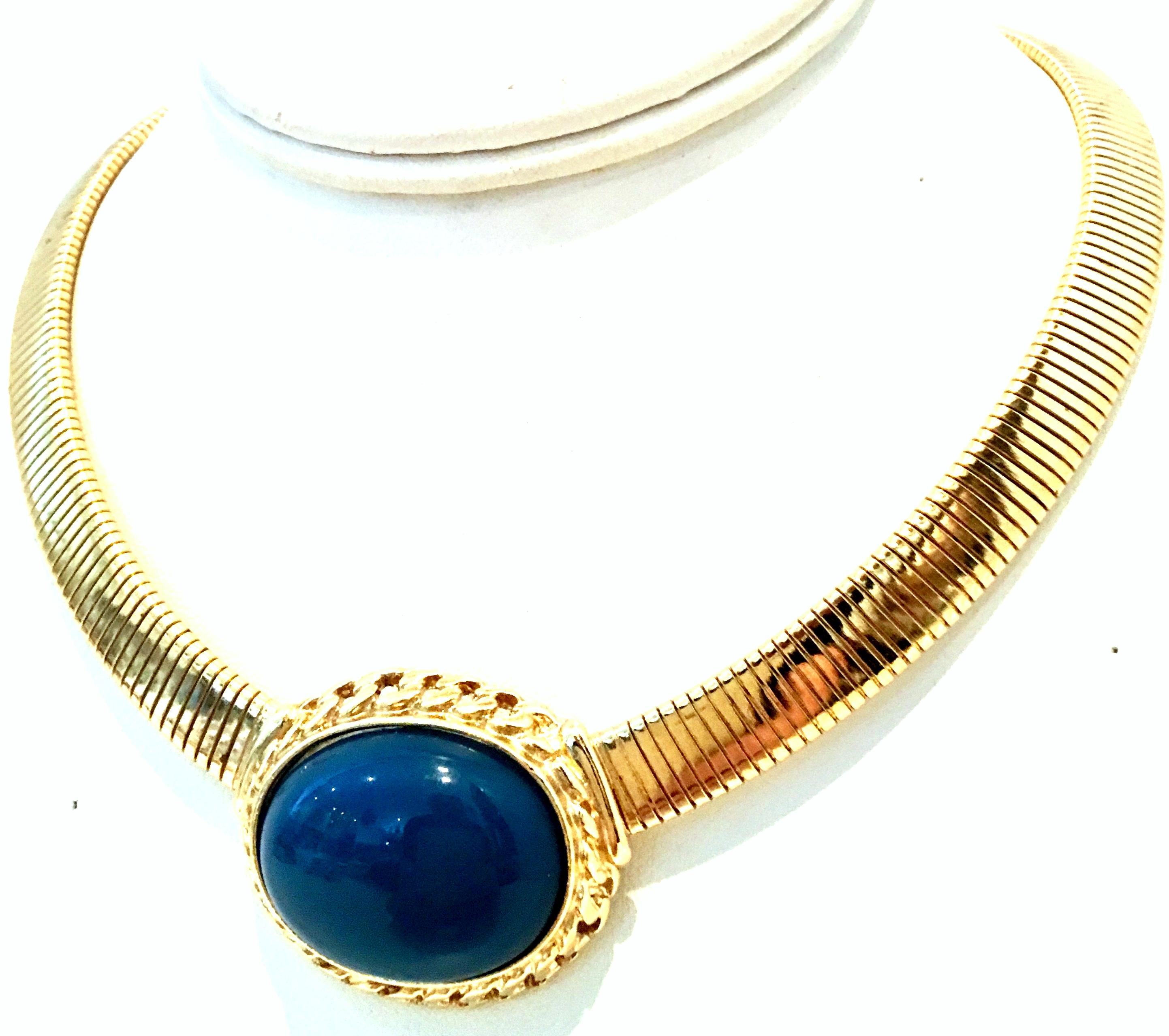 20th Century Gold Plate & Faux Blue Lapis Lazuli Omega Choker Necklace By, Trifari. This gold plate omega style choker necklace features a large oval cabochon set faux blue Lapis Lazuli stone of approximately, 1.13