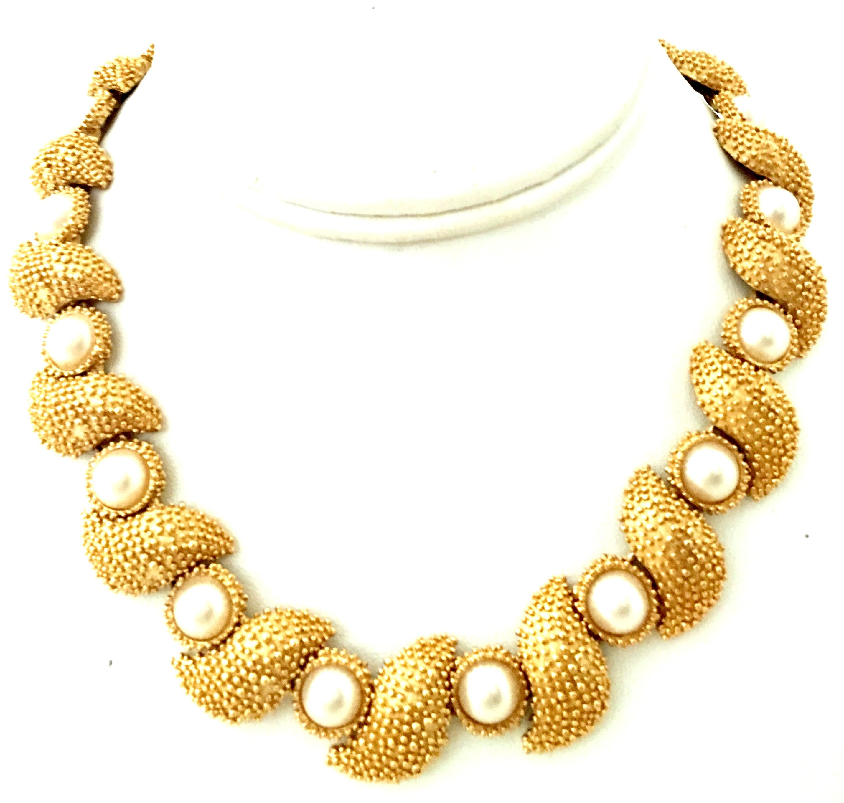 20th Century Gold Plate & Faux Pearl Necklace And Bracelet By, Trifari-Set Of Two Pieces. This coveted gold plate link necklace and bracelet features a gold plate high relief textured ground with cabochon set round white faux pearls.Each pearl is