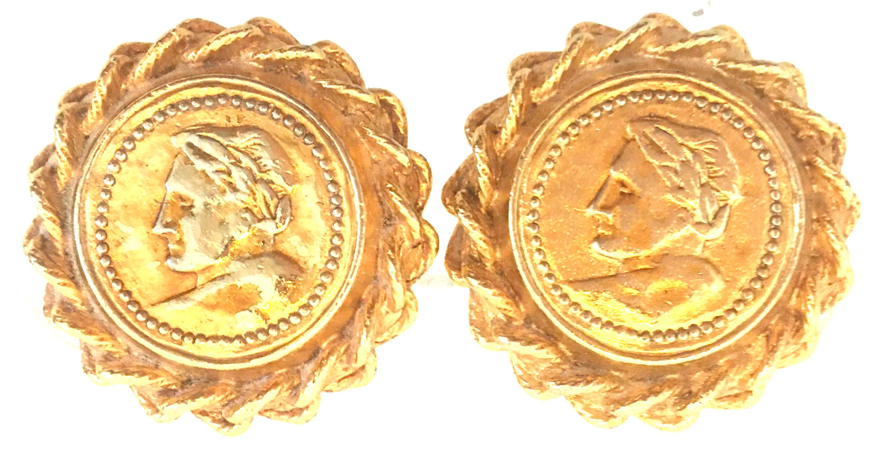 20th Century Gold Plate Roman Coin Pair Of Earrings By, Carlisle. This large pair of clip style dimensional earrings feature gold plate with raised Male Roman Bust motif, raised bead surround and large twisted rope style detail. Each earring is