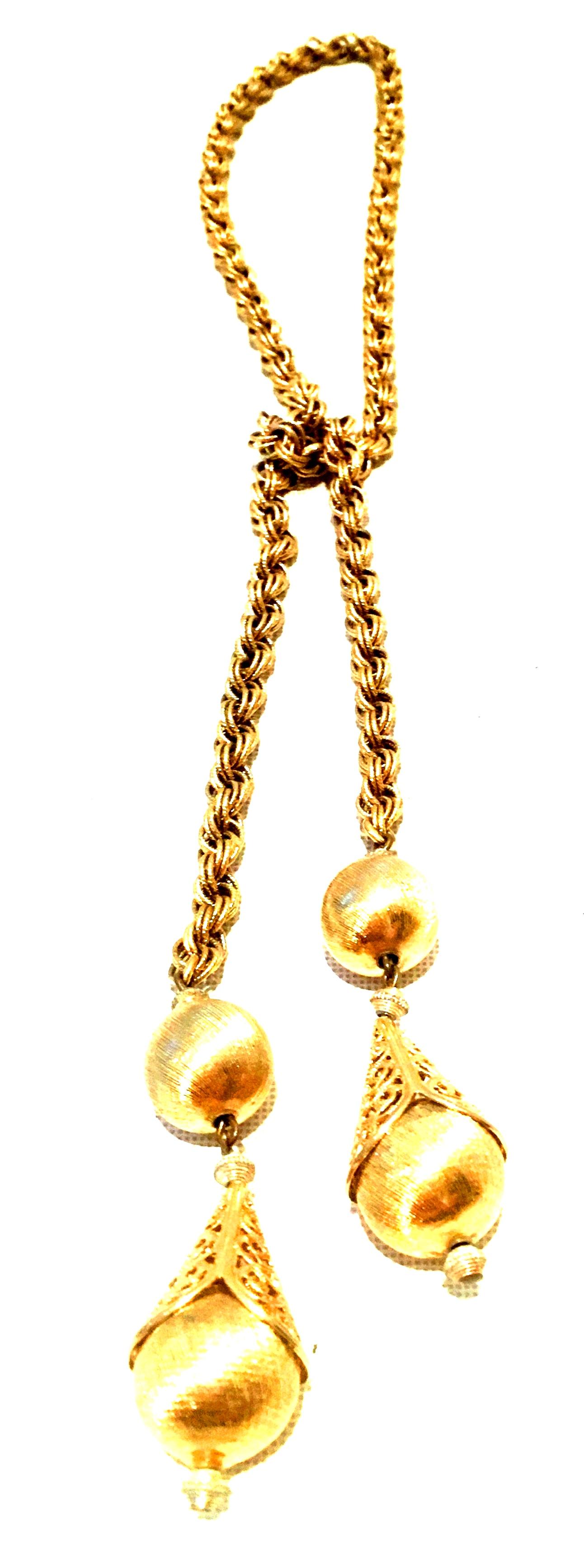 20th Century Gold Plate Rope Lariat Necklace. This long rope style gold plate Lariat necklace can be worn in several ways. The bottom two ornaments hand approximately 3