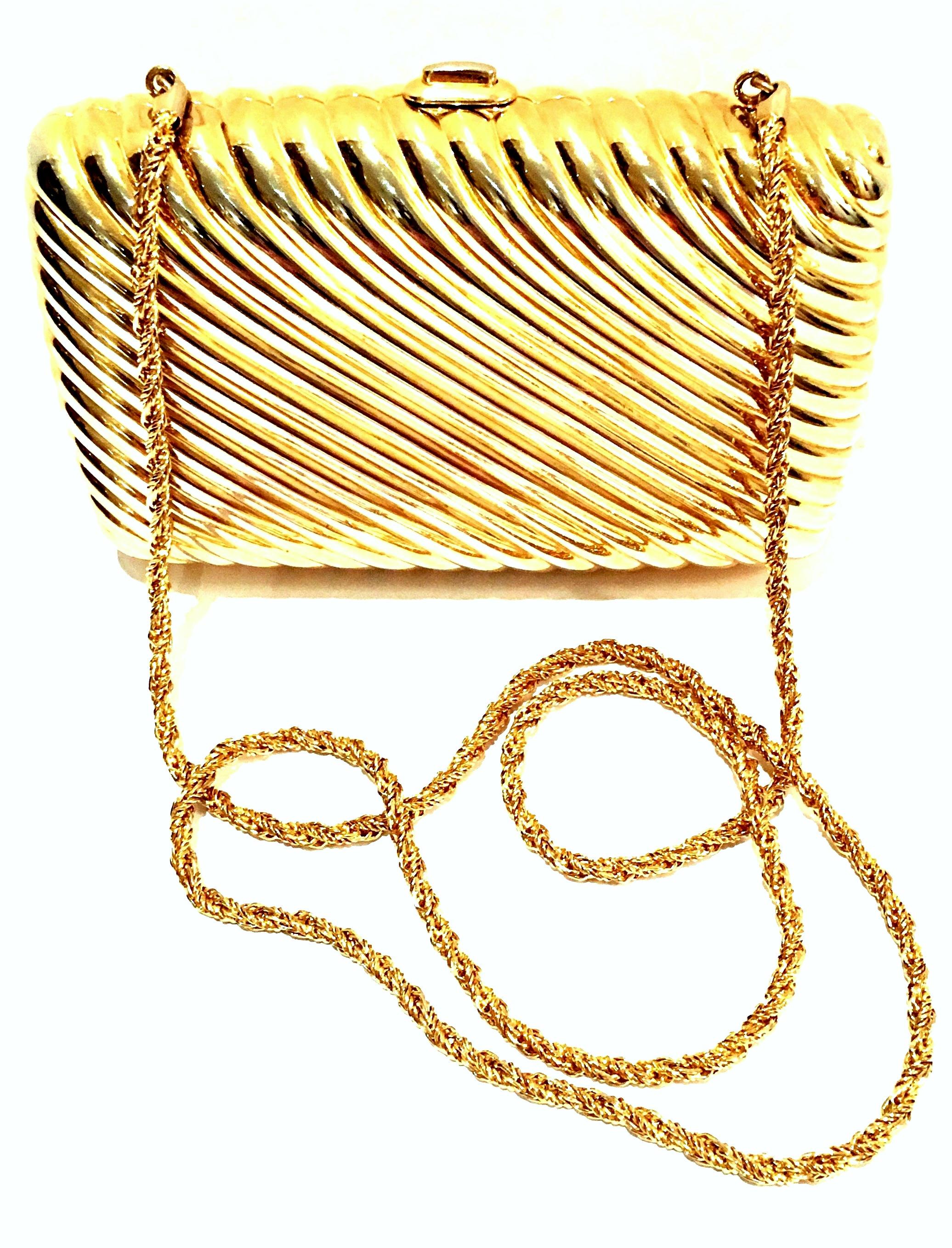 20th Century Gold Gilt Ribbed minaudiere box clutch evening bag by, Judith Leiber. This Classic & Timeless Judith Leiber gold plated metal hard case ribbed minaudière evening bag can be used as a clutch or shoulder bag. Features a simple gold snap
