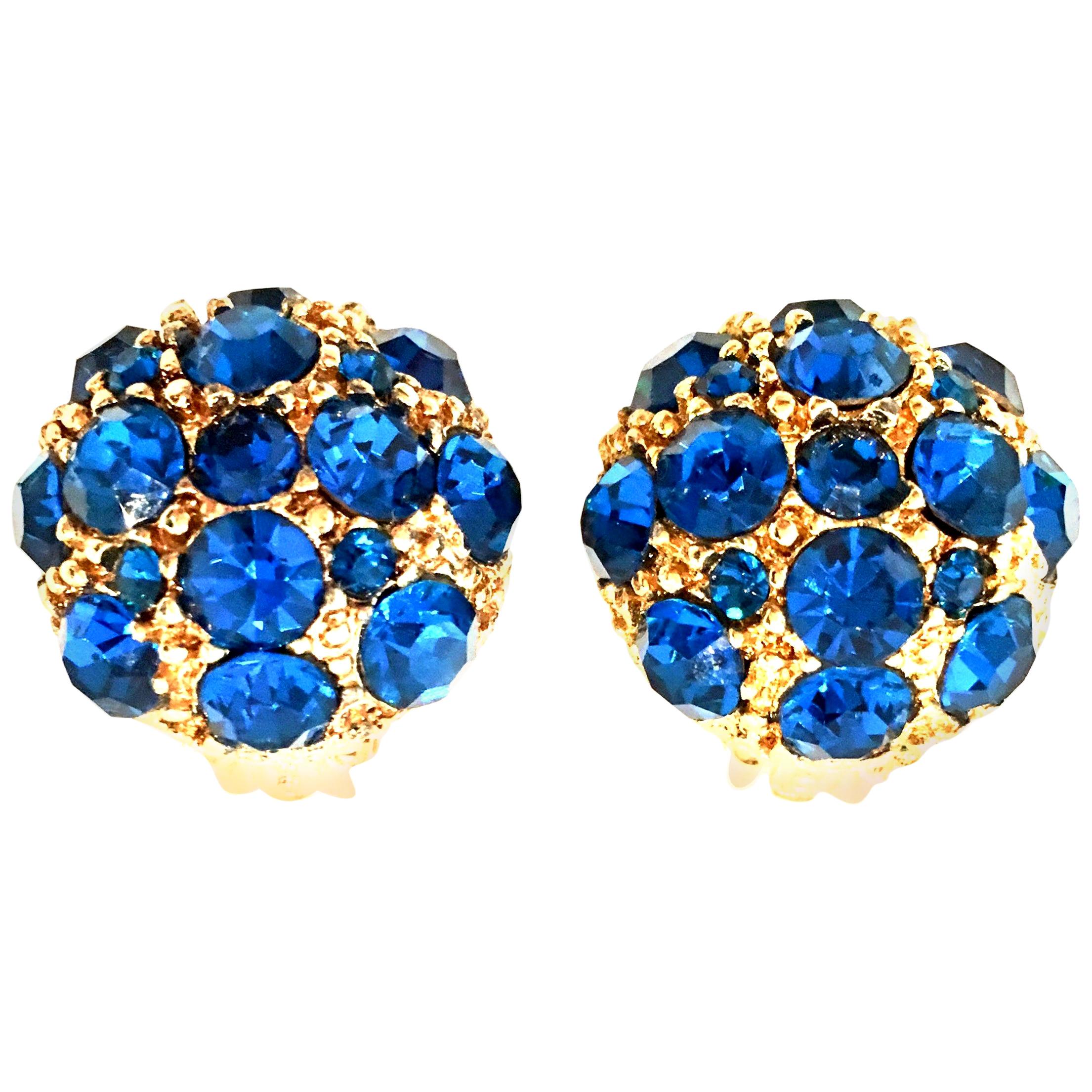 20th Century Gold Plate & Sapphire Blue Swarovski Crystal Rhinestone Dimensional Dome Clip Style Earrings. Features gold plate textured and beaded ground with brilliant paste set round sapphire blue Swarovski crystals.