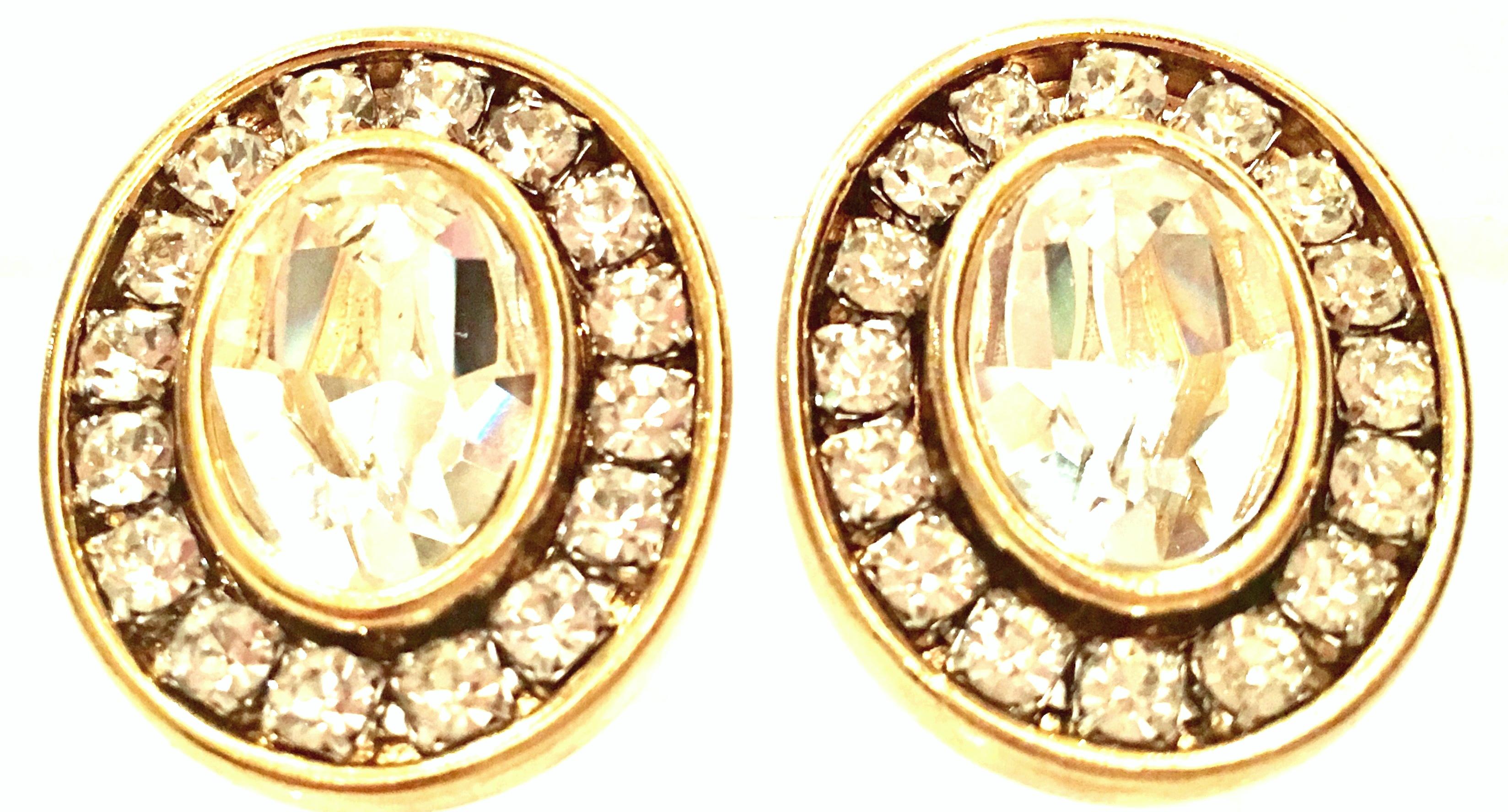 20th Century Gold Plate & Swarovski Crystal Earrings By, Givenchy.  These finely crafted gold plate earrings feature, channel prong set colorless stones with a large cut and faceted central stone of approximately, .50