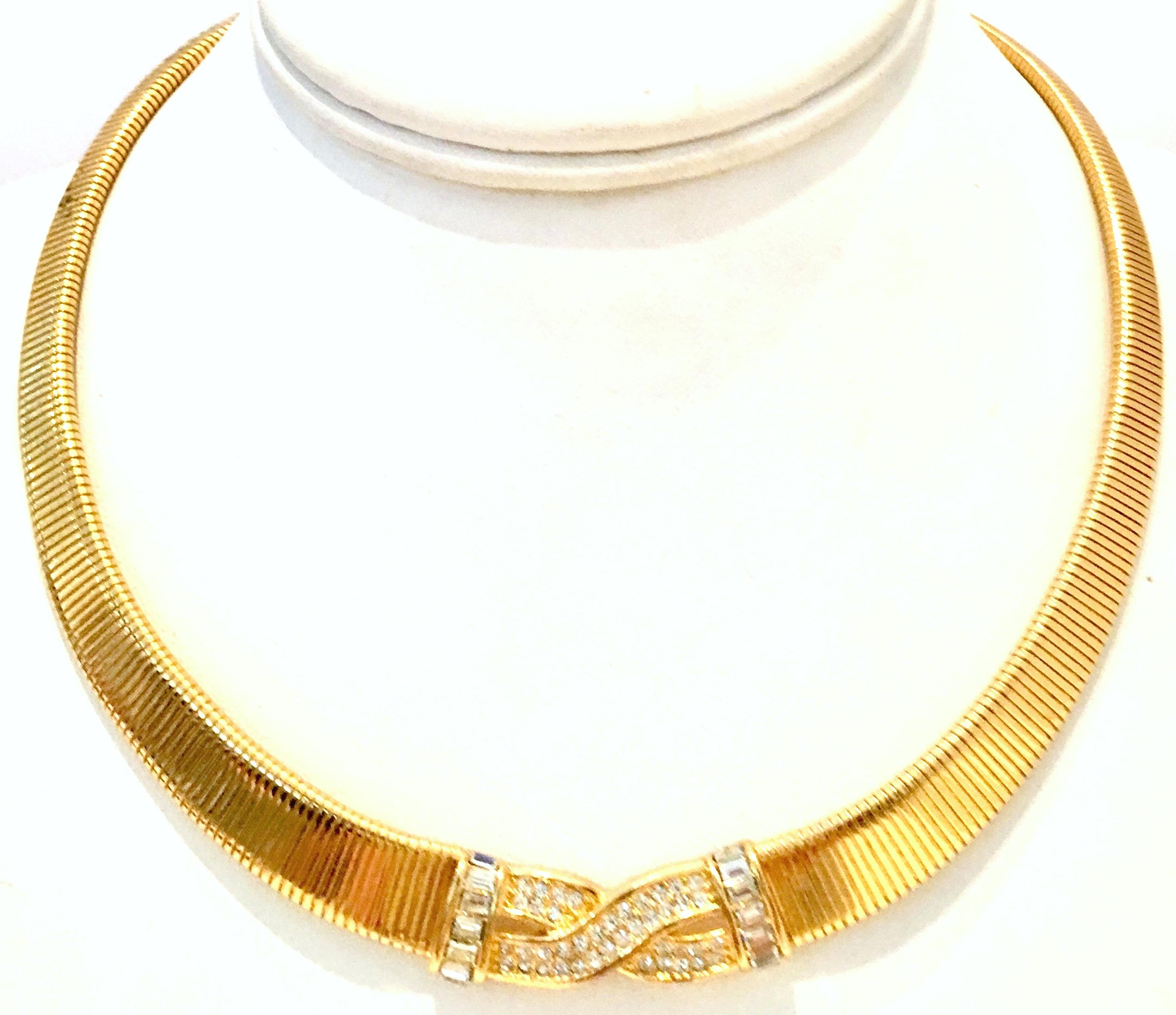 20th Century Gold Plat & Swarovski Crystal Choker Style Necklace By, Christian Dior. Features a gold plate textured necklace with a central Swarovski crystal clear rhinestone paste set detail. The fold over box clasp is adjustable and features a 