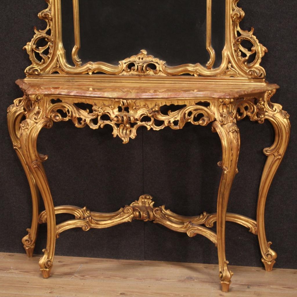 Console with mirror, Italy, mid-20th century. Furniture in richly carved and gilded wood in Louis XV style complete with original marble top. Mirror of large size and impact resting for a long time on the marble top, to be fixed separately for