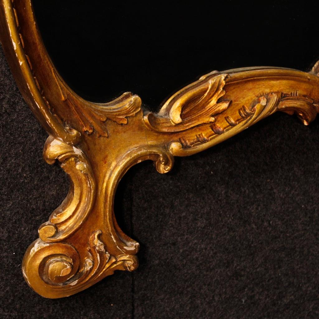 Italian mirror from 20th century. Furniture in carved and gilded wood (bronze color) of beautiful size and quality. Mirror ideal to combine with a dresser or bureau. Furniture that has some small drops of color, overall in good state of conservation.