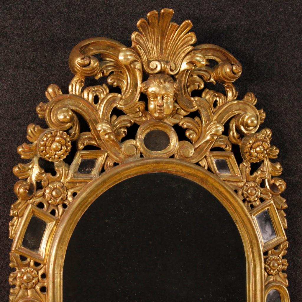 Spanish mirror from the first half of the 20th century. Great mirror pleasantly sculpted and gilded. Object decorated with small side mirrors and little angel on the moulding, of great charm. Mirror that can be easily inserted into different parts