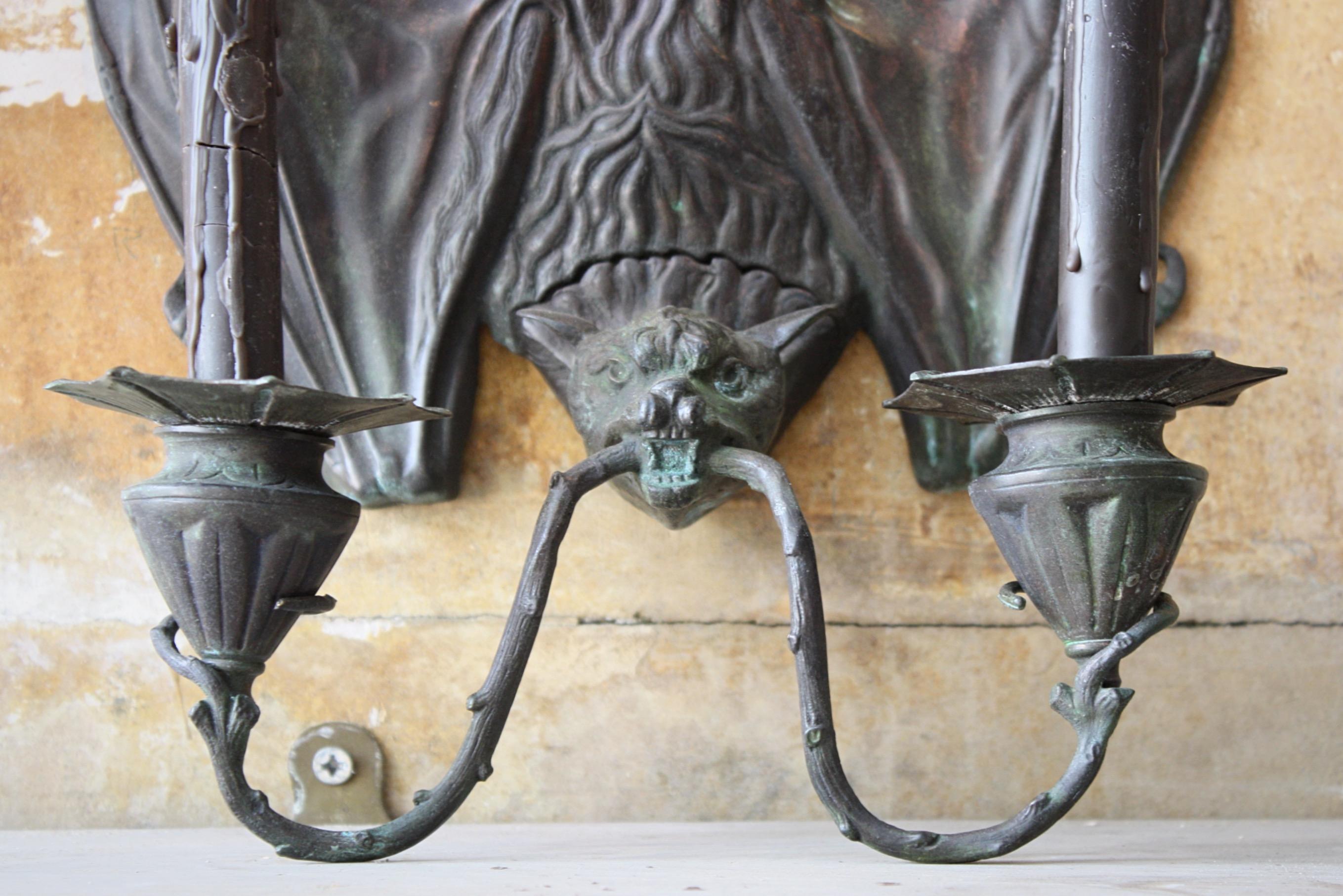 A pair of scarce late 20th century bronze Victorian-style bat wall sconces after the original design by William Tonks & Sons for Liberty's, designed at the Keswick School of Industrial Arts. 

Both sconces are very well made and crisply cast from